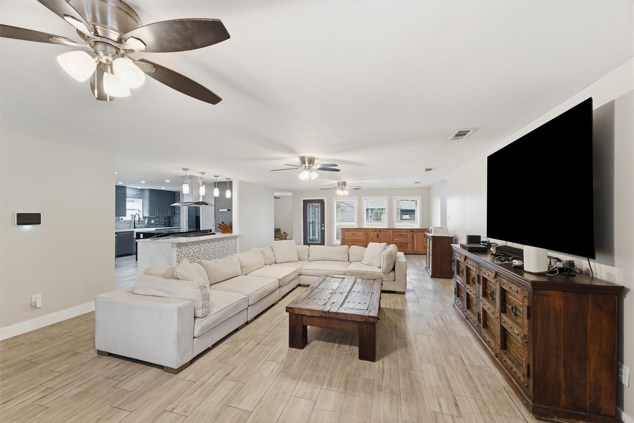 The living room flows seamlessly into the kitchen, creating an open and inviting space for everyday living and entertaining.