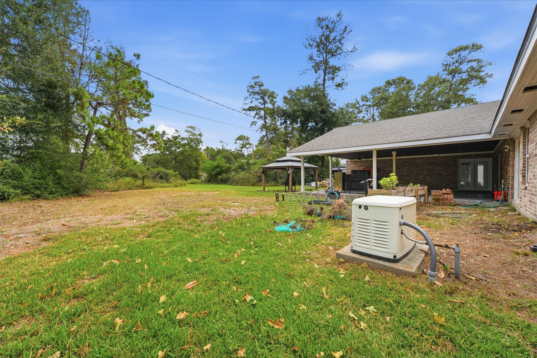 A view of the backyard showcases the spacious outdoor area. The open layout provides room for outdoor activities.