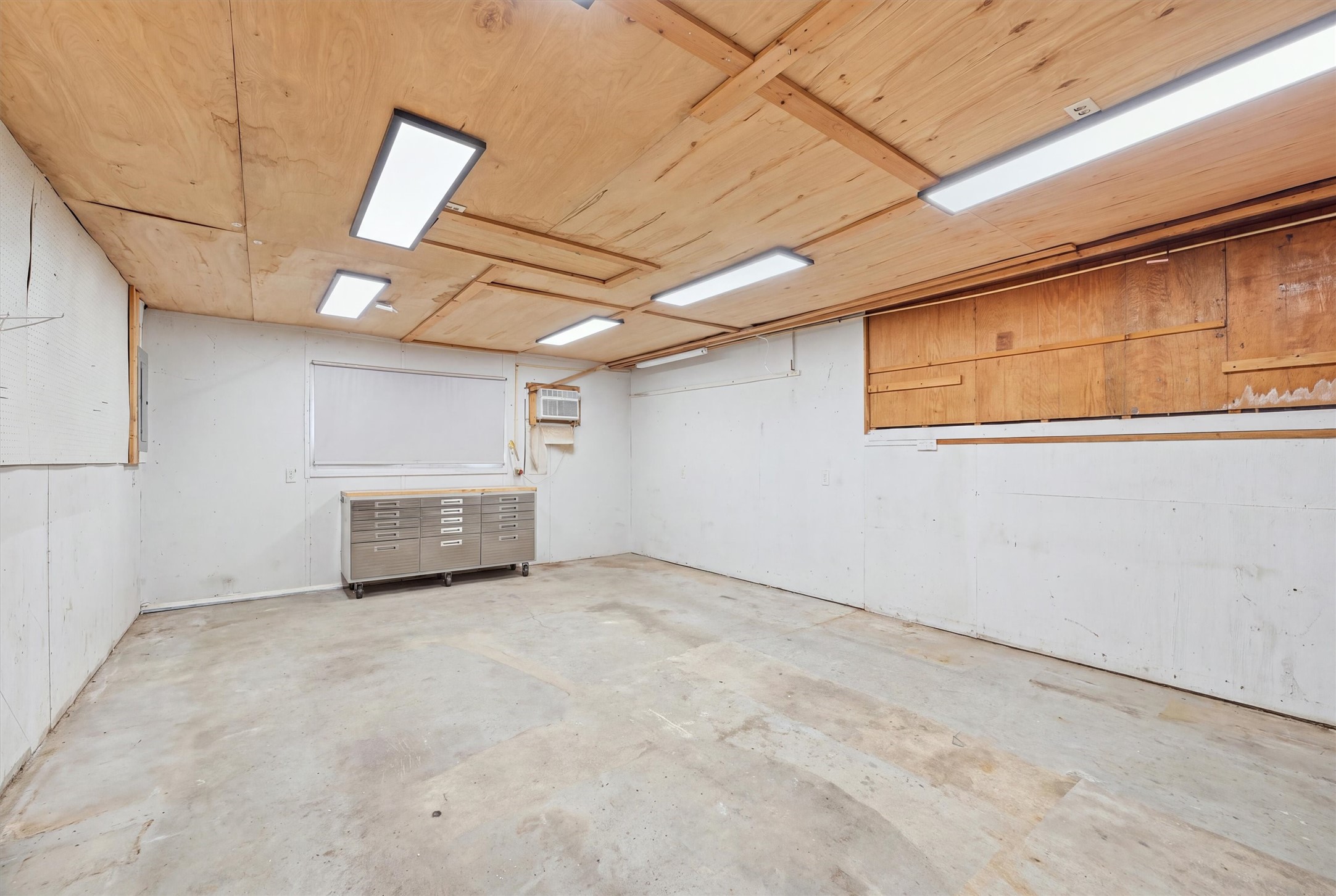 Located just off the dining and breakfast area, this dedicated indoor workshop offers a separate space for woodworking, DIY projects, and hobbies, with concrete flooring and overhead lighting.