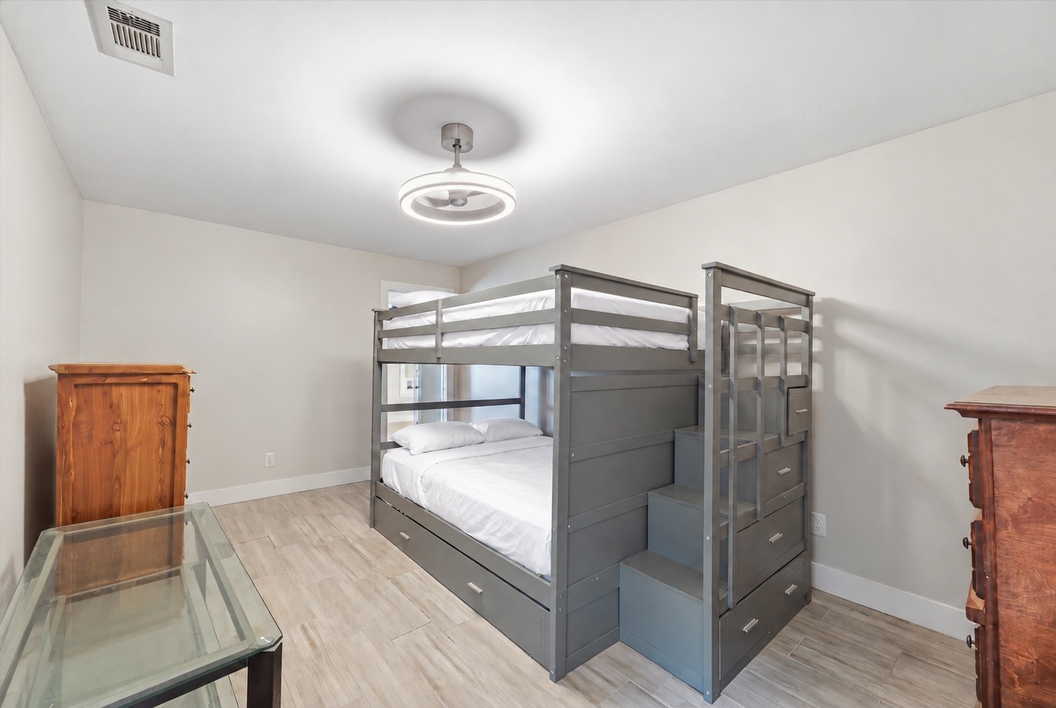 This versatile flex room is accessible from both the second primary suite and the front hallway, offering flexibility for a home office, hobby room, gaming room, or private sitting area.