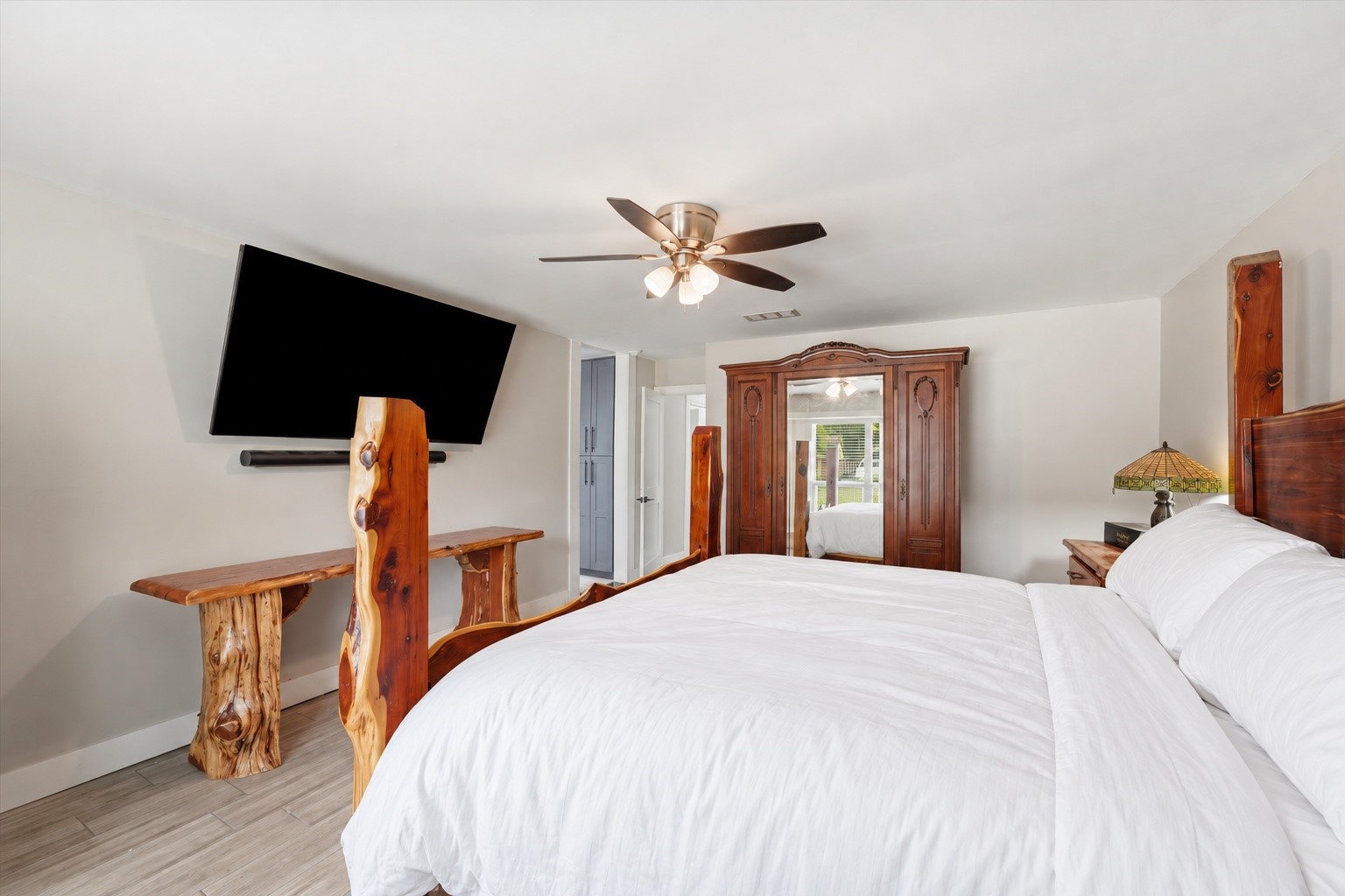 Another view of the main primary suite, showing the room's layout and access to the adjoining bathroom.
