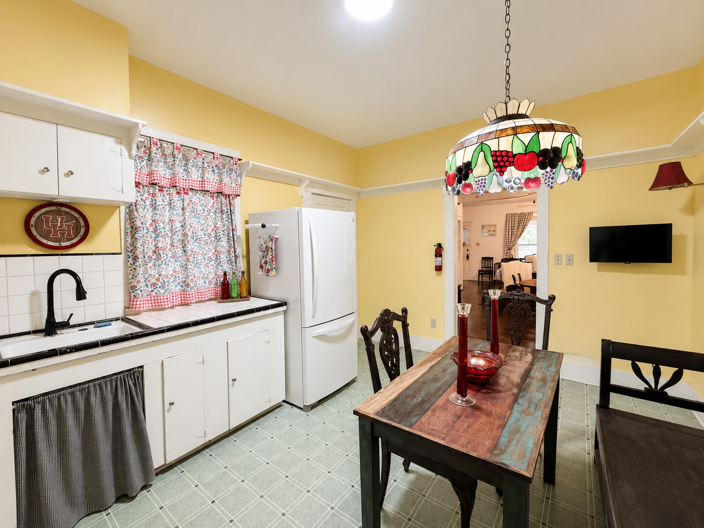 Alternate view highlights the sink area, ample cabinetry, and room for a full dining table. A wide doorway provides an easy connection to the adjoining living space.