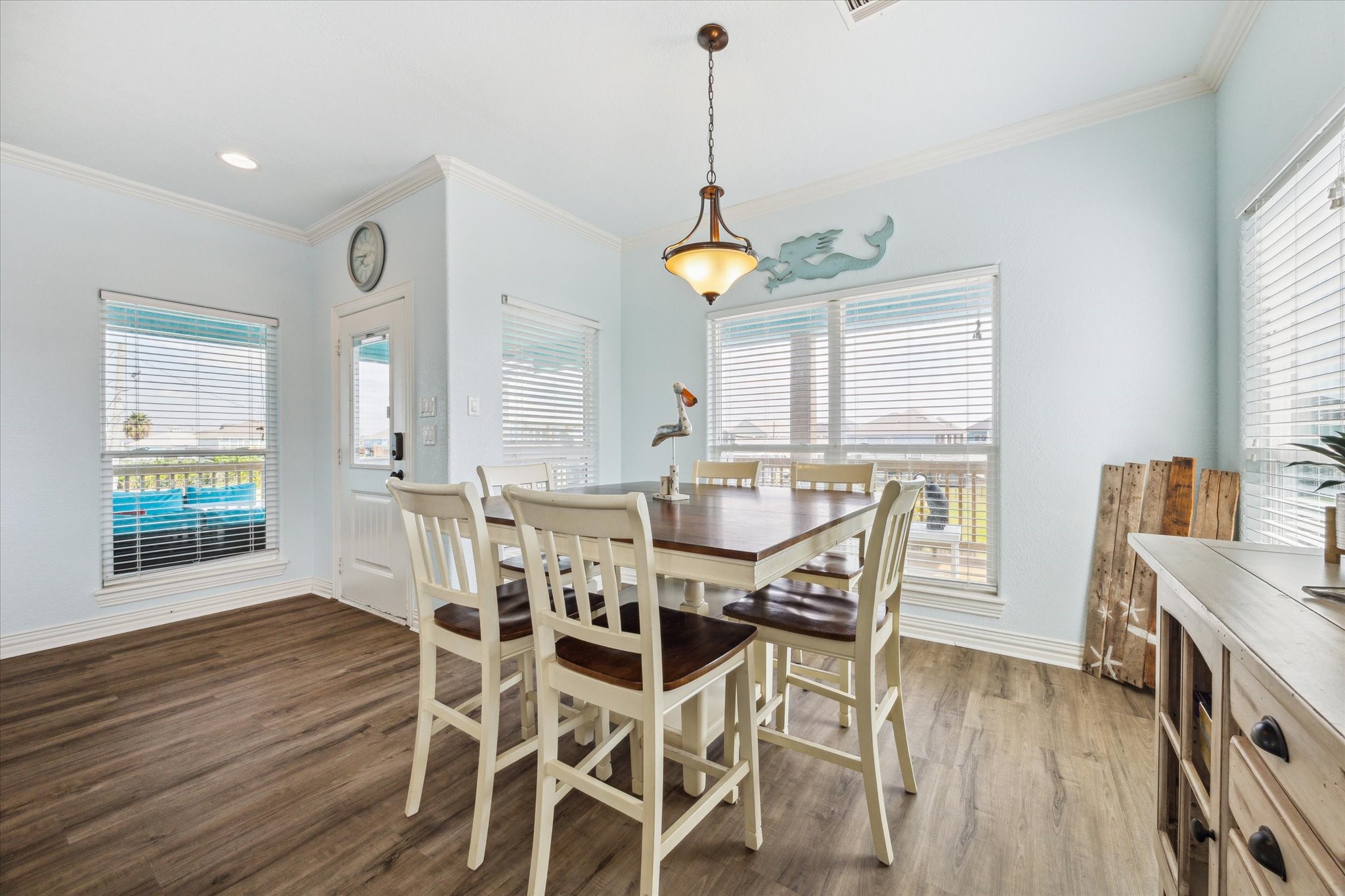 Off the family room, you'll find the dining room, a bright and airy space surrounded by windows that let in an abundance of natural light. It's truly one of the best rooms in the house, offering a perfect setting for meals gatherings, and late night game nights while enjoying scenic views!