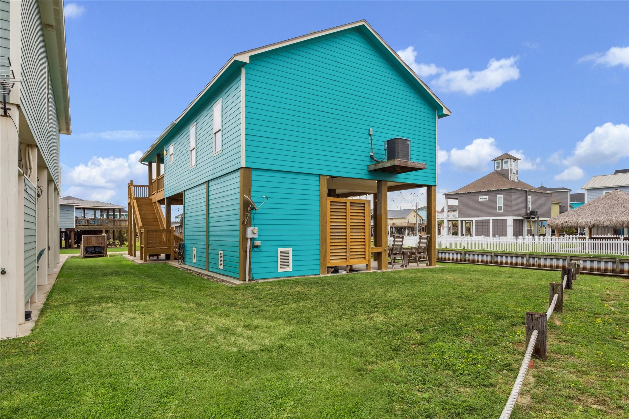 NEW AC unit - September 2025. View of the side yard and backyard.