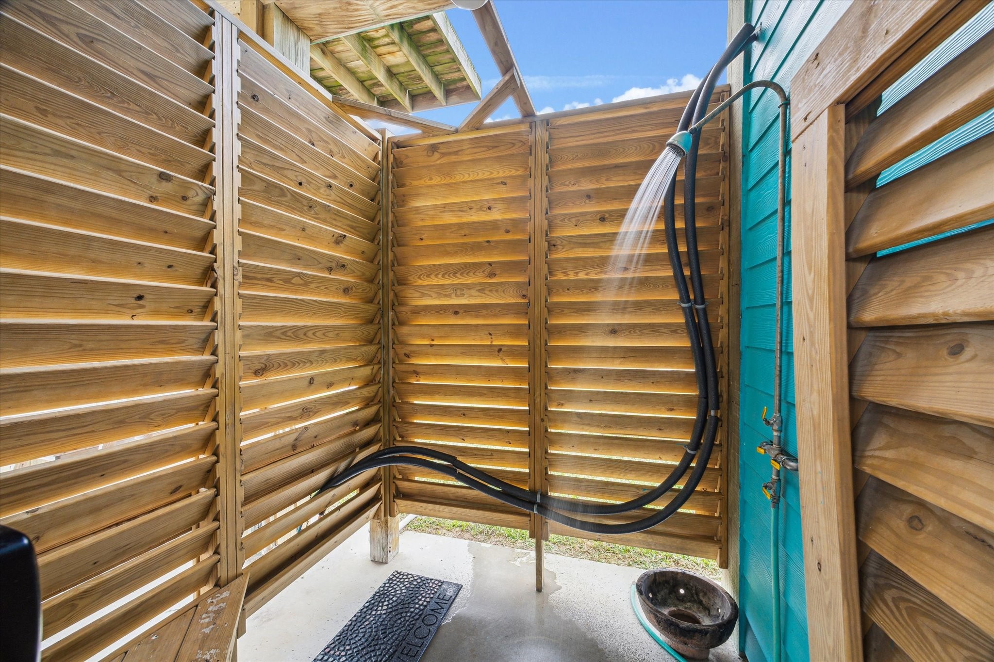 This beach house features a convenient outdoor shower, completed with hot water, perfect for rinsing off sand and salt after a day at the beach. It offers privacy, comfort, and a refreshing way to enjoy the coastal atmosphere. This beach house features a convenient outdoor shower, completed with hot water, perfect for rinsing off sand and salt after a day at the beach. It offers privacy, comfort, and a refreshing way to enjoy the coastal atmosphere.