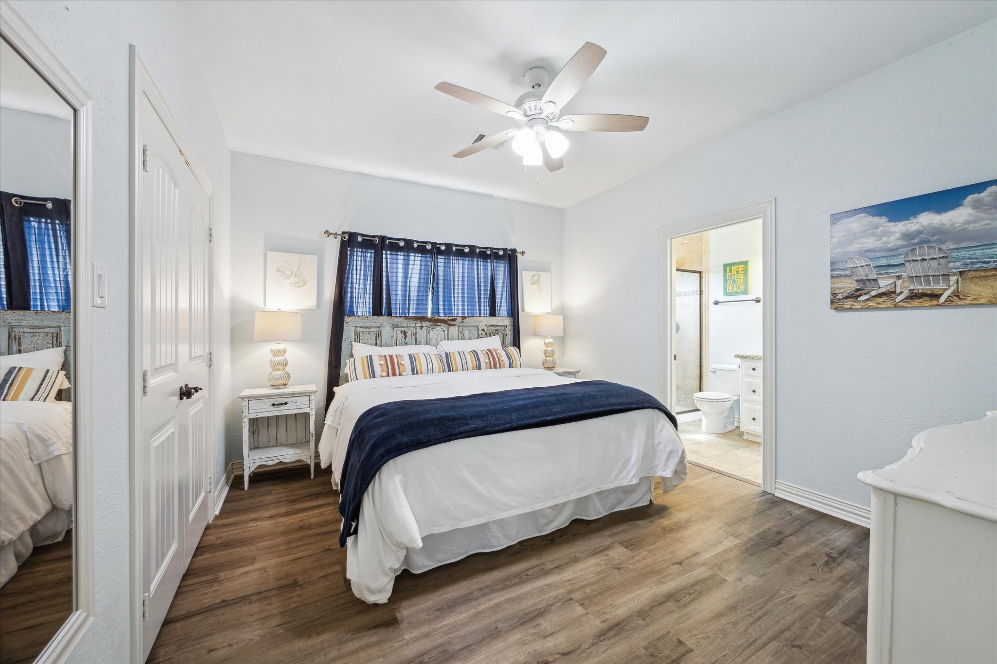 Spacious primary bedroom filled with natural light, offering ample closet space and an ensuite bathroom featuring a walk-in shower.