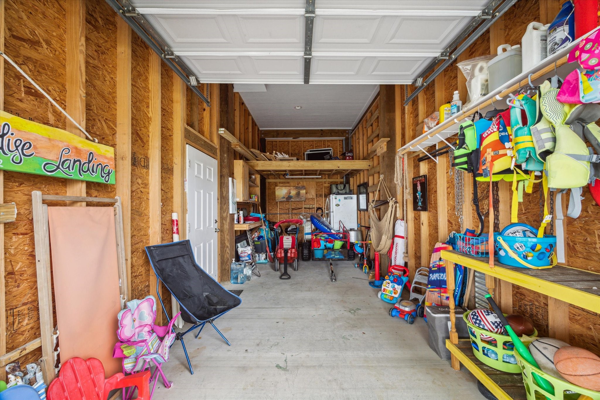 Spacious garage with plenty of storage, perfect for all your beach supplies, golf cart, or anything else you need to make the most of your coastal lifestyle. Everything you see here, is included with the sale. Extra refrigerator for all food and drinks! Spacious garage with plenty of storage, perfect for all your beach supplies, golf cart, or anything else you need to make the most of your coastal lifestyle. Everything you see here, is included with the sale. Extra refrigerator for all food and drinks!