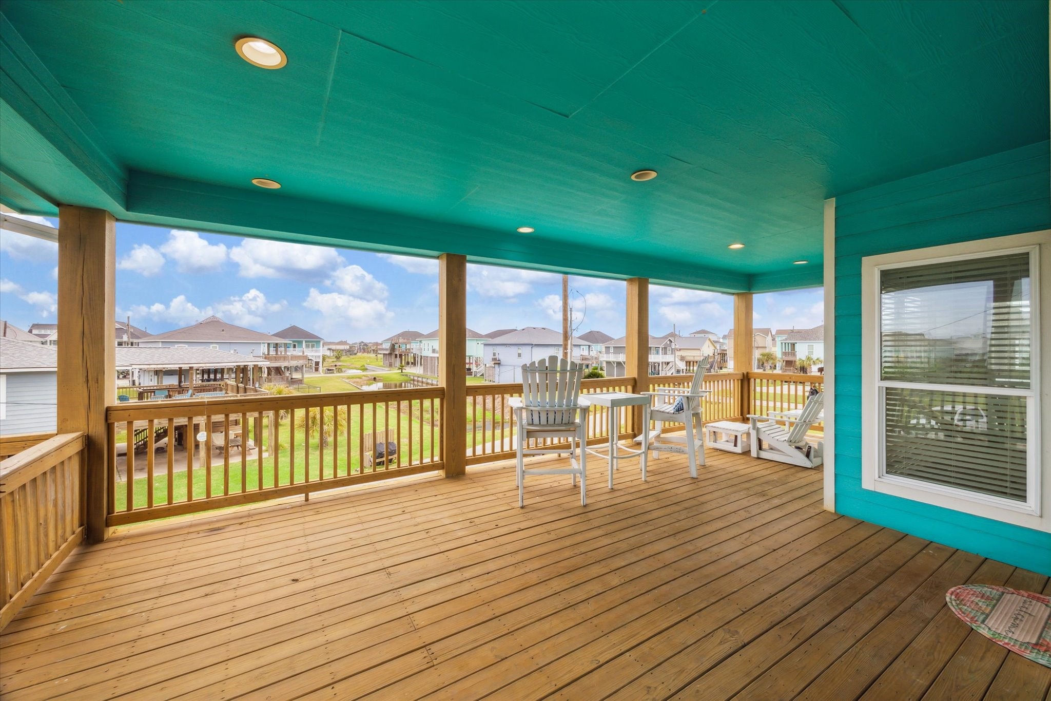 A view of the entry landing leading to the expansive, covered balcony  perfect for entertaining and taking in the gorgeous views.