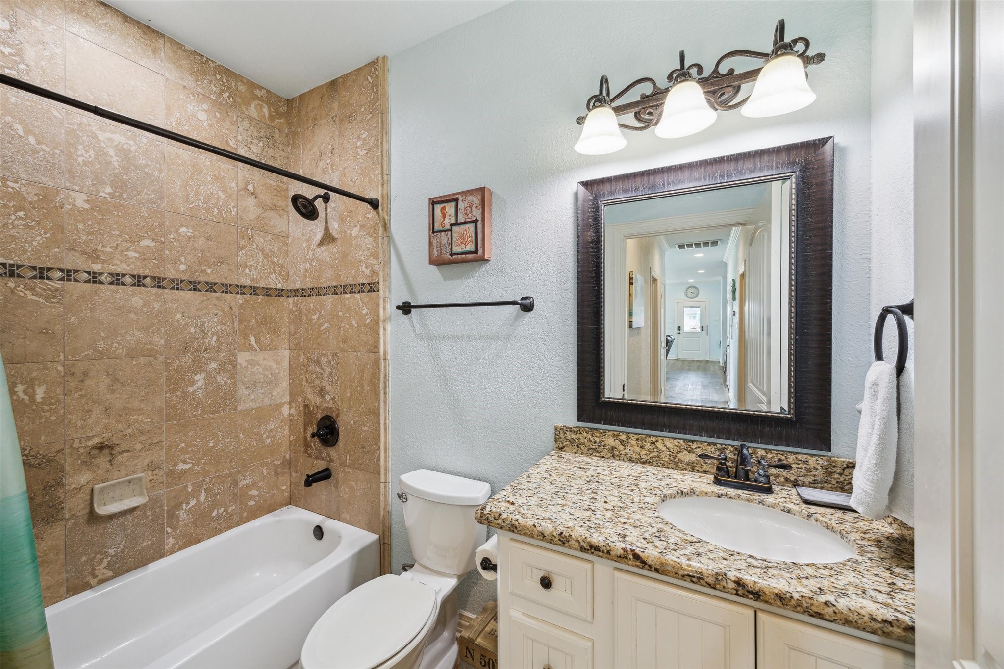 Secondary bathroom with a tub / shower combo.
