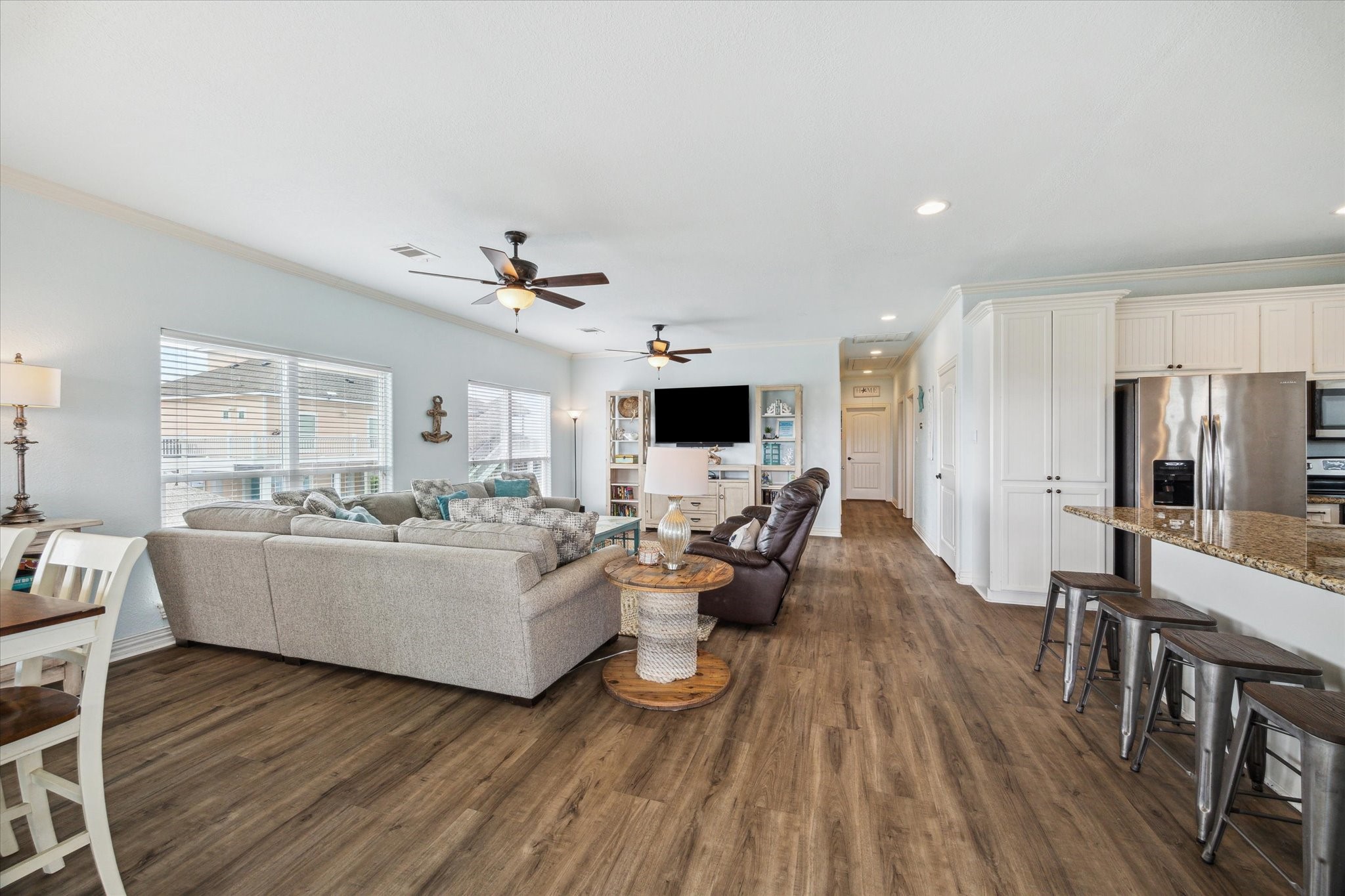 Additional view of the family room, featuring the hall to the bedrooms, bathrooms and laundry space.
