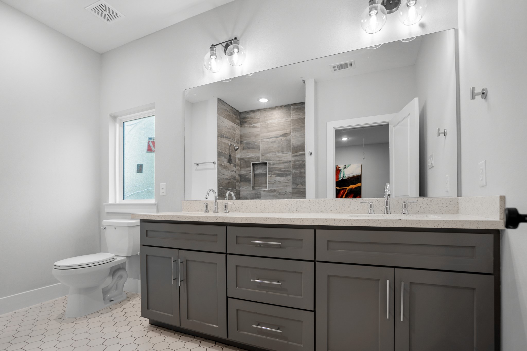 The secondary bathroom is a stylish retreat, boasting modern fixtures and sleek design elements that elevate the space to new heights of sophistication. Photos are of previous model home.