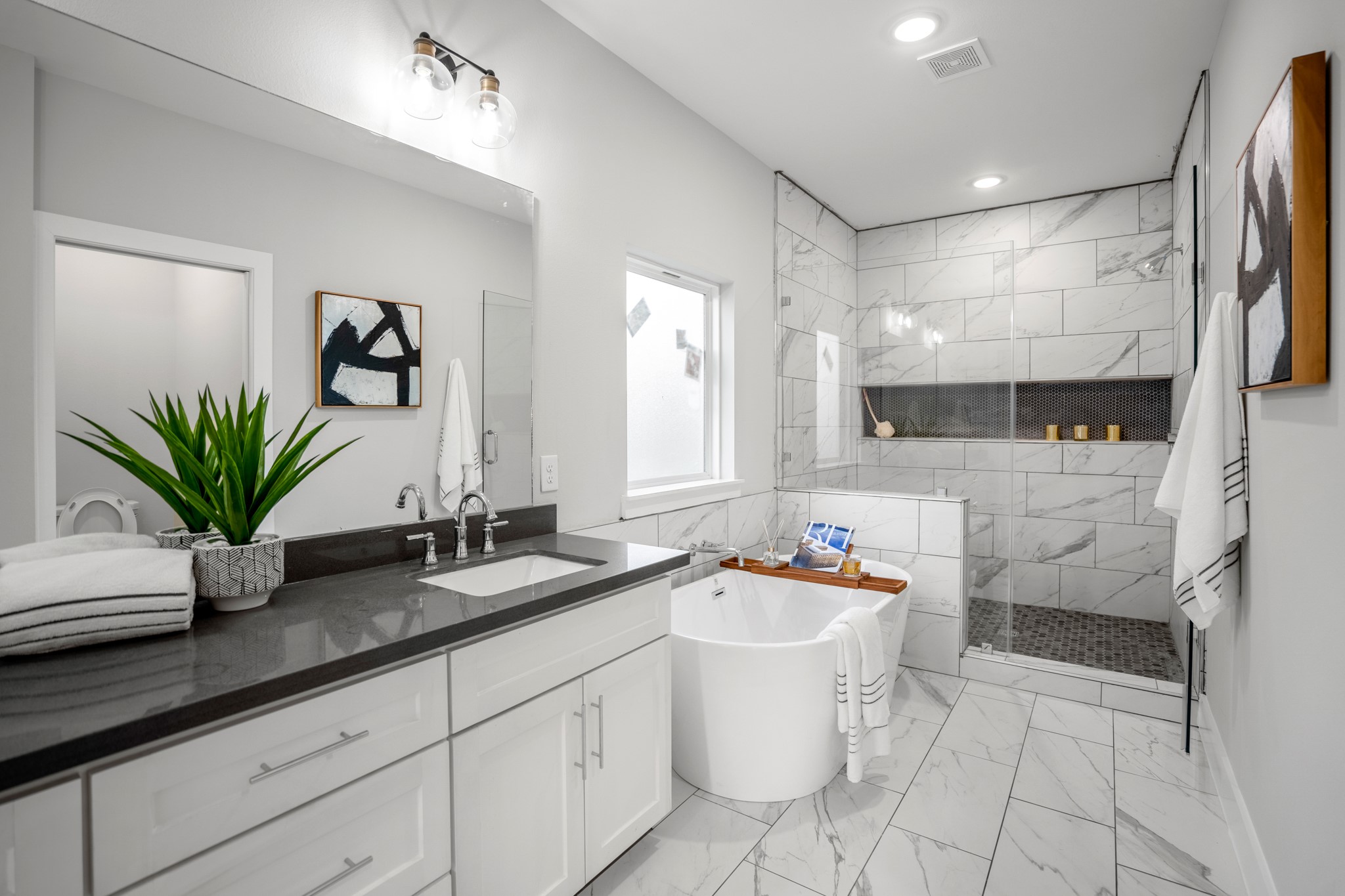 Step into the master bathroom, where dual sinks, a standalone tub, and a frameless shower offer a spa-like retreat. Photos are of previous model home.