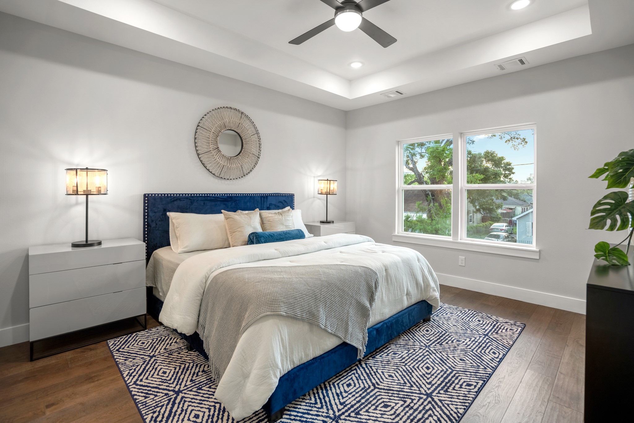 Master bedroom features a beautiful tray ceiling design as well as recessed LED lighting along 6 inch plank floors. Photos are of previous model home.
