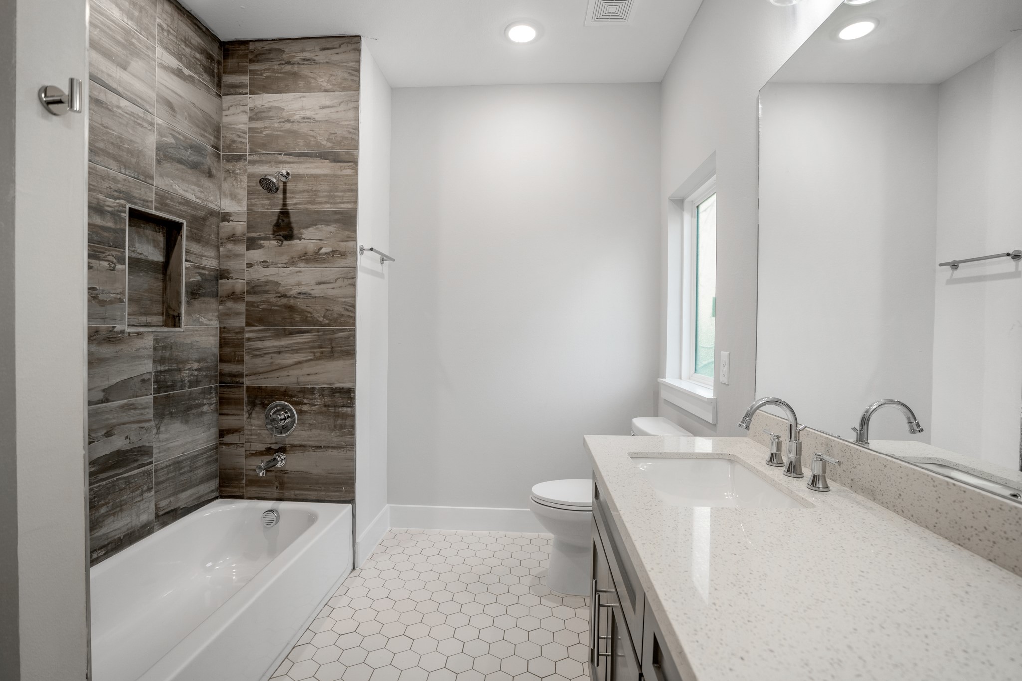 With its clean lines, contemporary finishes, and ample counter space, this chic sanctuary offers a refreshing escape for guests or family members alike. Photos are of previous model home.