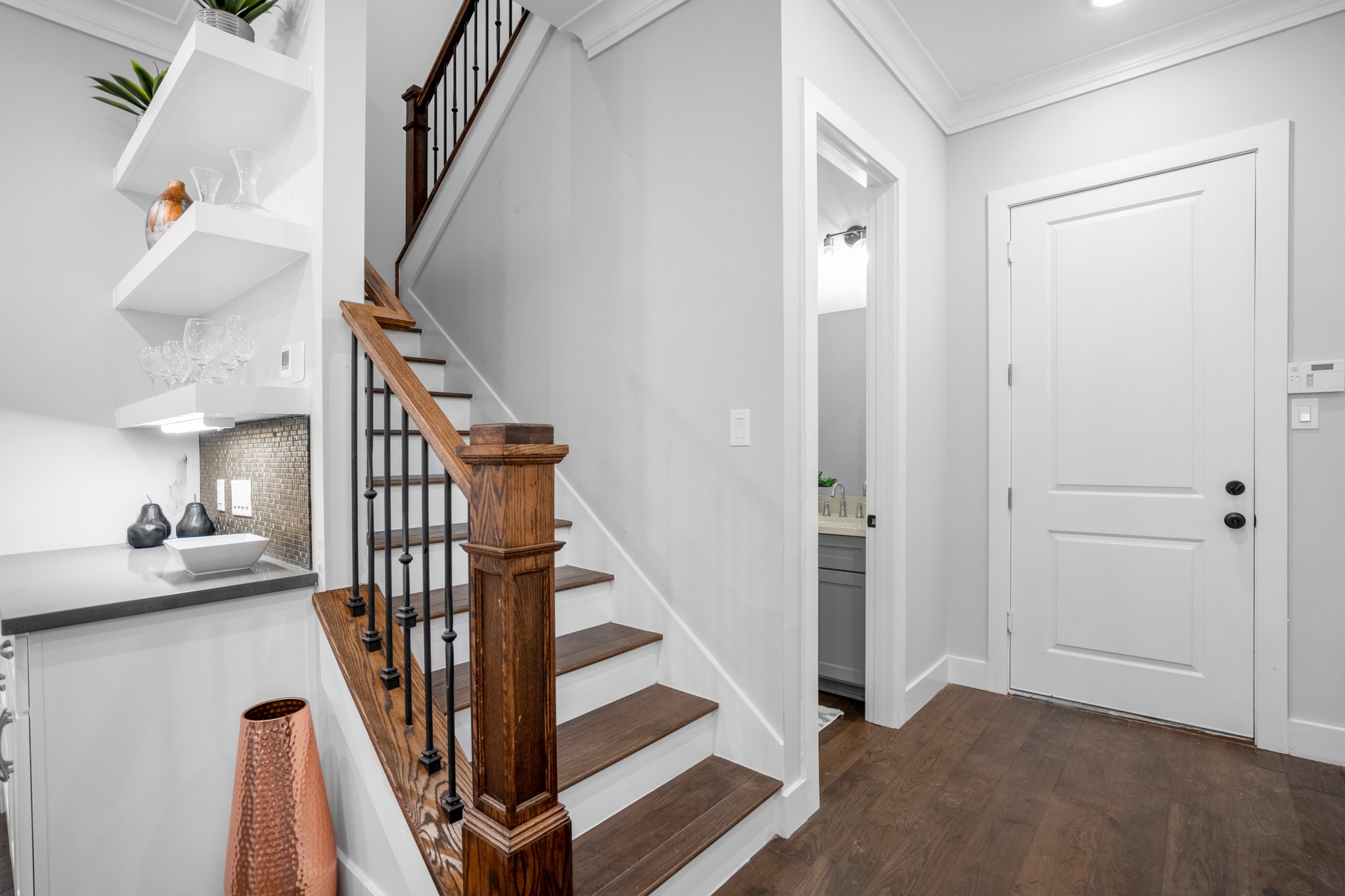 The stairwell serves as a striking architectural accent, with its graceful  and sleek railing design adding visual interest and sophistication to the home's interior. Photos are of previous model home.
