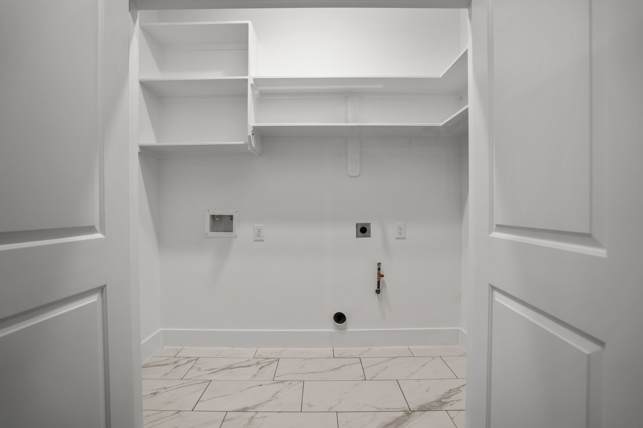 The laundry room serves as a functional hub for household chores, offering a well-organized space equipped with modern appliances and ample storage solutions. Photos are of previous model home.