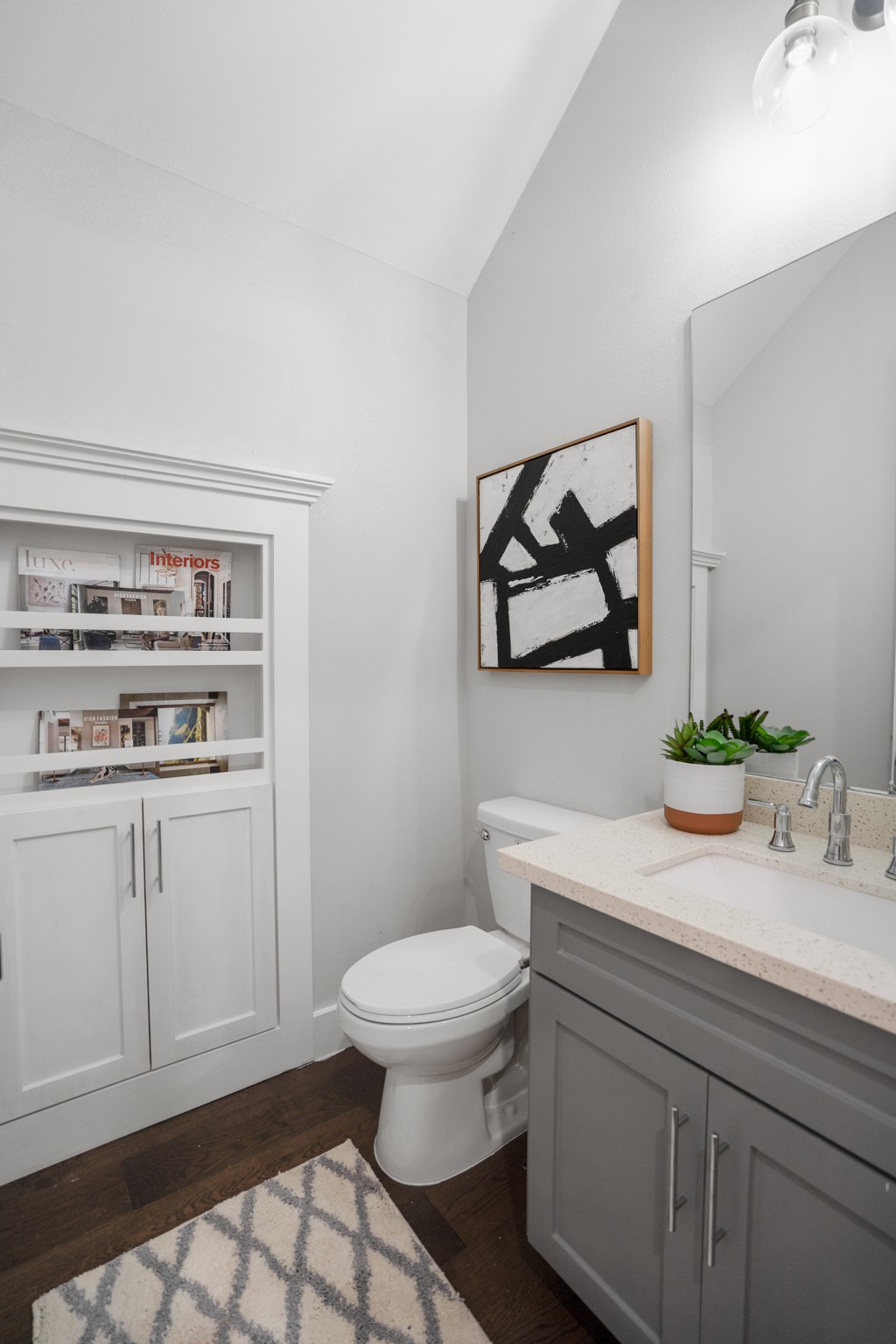 The half bath is a stylish sanctuary, featuring modern fixtures and chic design elements. Photos are of previous model home.