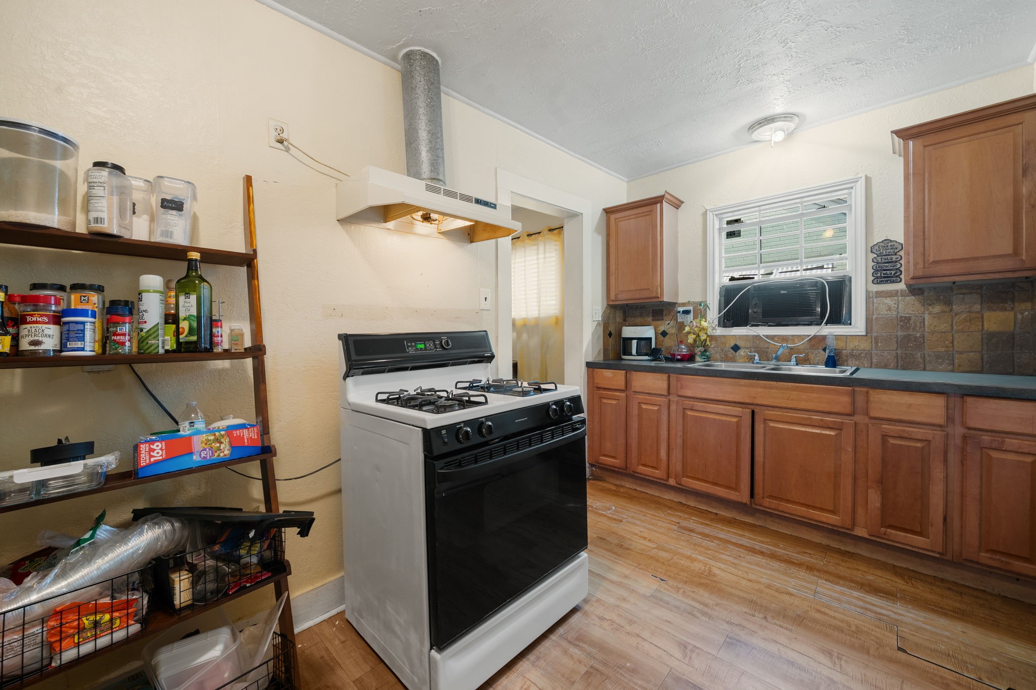 Wood color cabinets, updated counters make this kitchen a chef's dream.