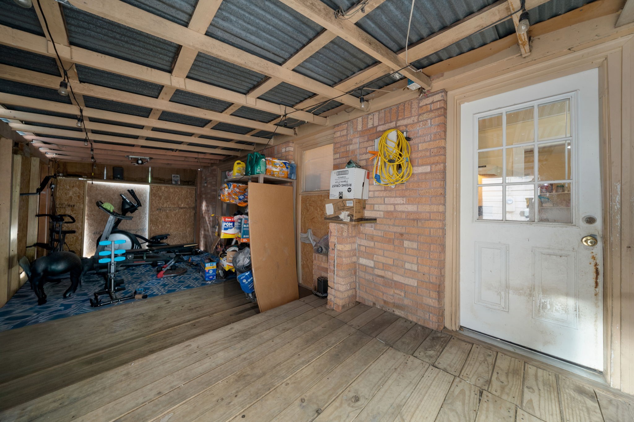 Covered washer and dryer area with lots of storage.