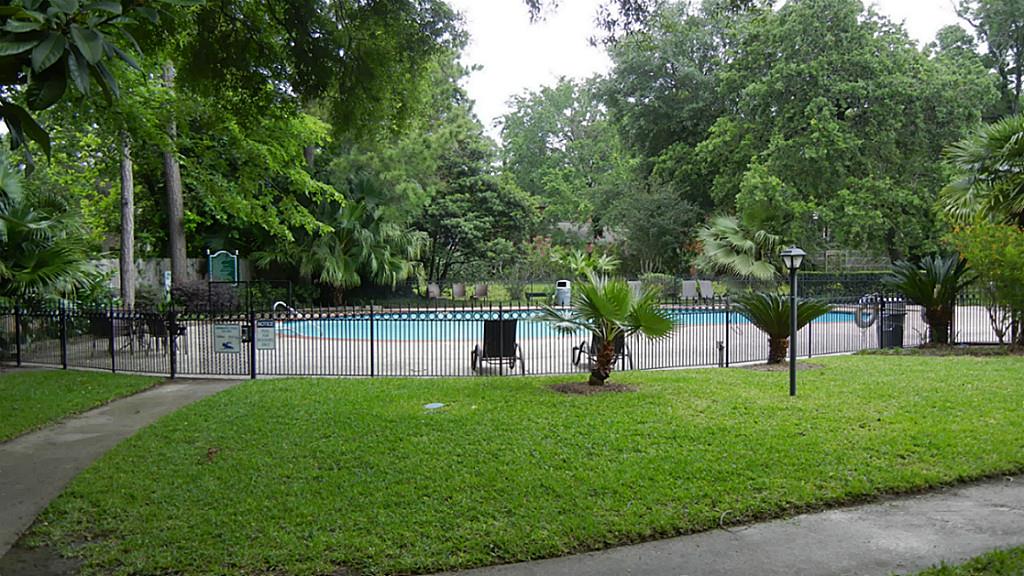 Lovely oasis view from your front door! Sparkling pool surrounding by lush landscaping.