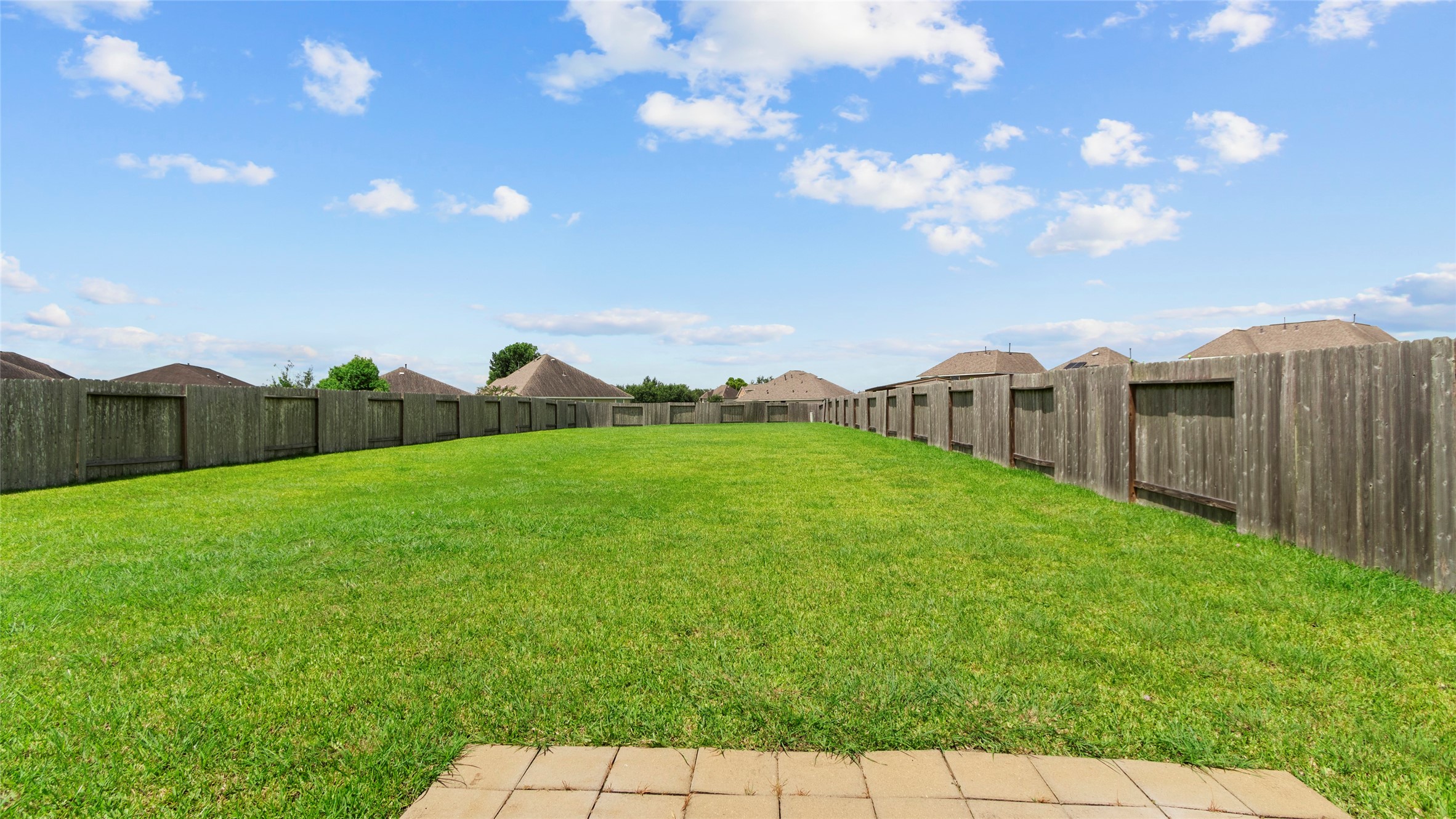 As you step outside, the oversized backyard opens up with plenty of room for pets, play, gardening, entertaining, and more.