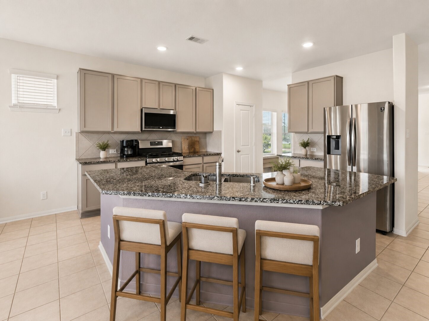 *virtually staged* A closer look at the oversized island, plentiful counter space and breakfast bar at the center of the home.