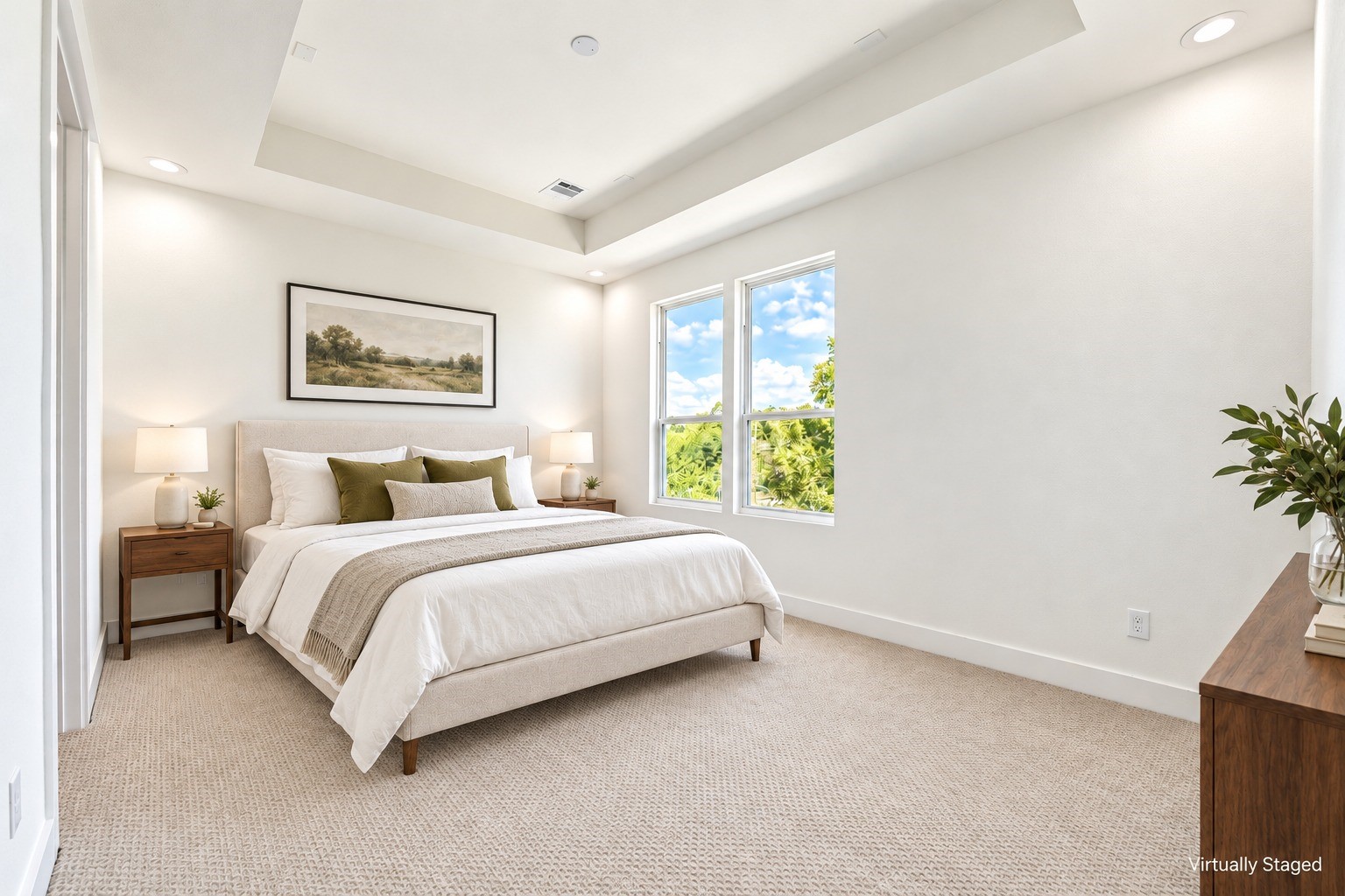 Bright and airy primary suite featuring an elegant tray ceiling, neutral palette, and large windows. *Virtually staged
