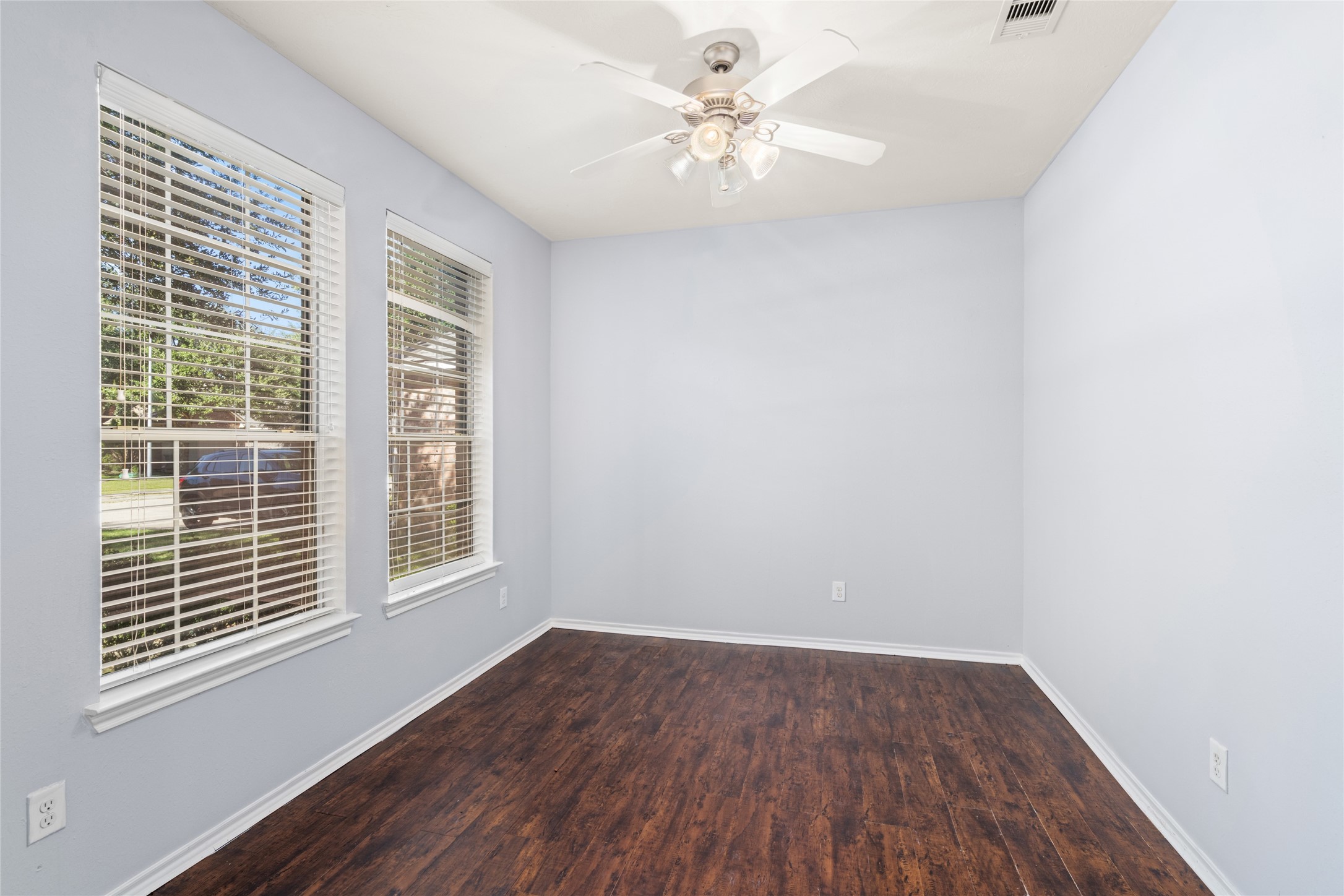 Bright and inviting, this home office/study features abundant natural light and elegant wood flooring, creating the perfect atmosphere for productivity and focus.