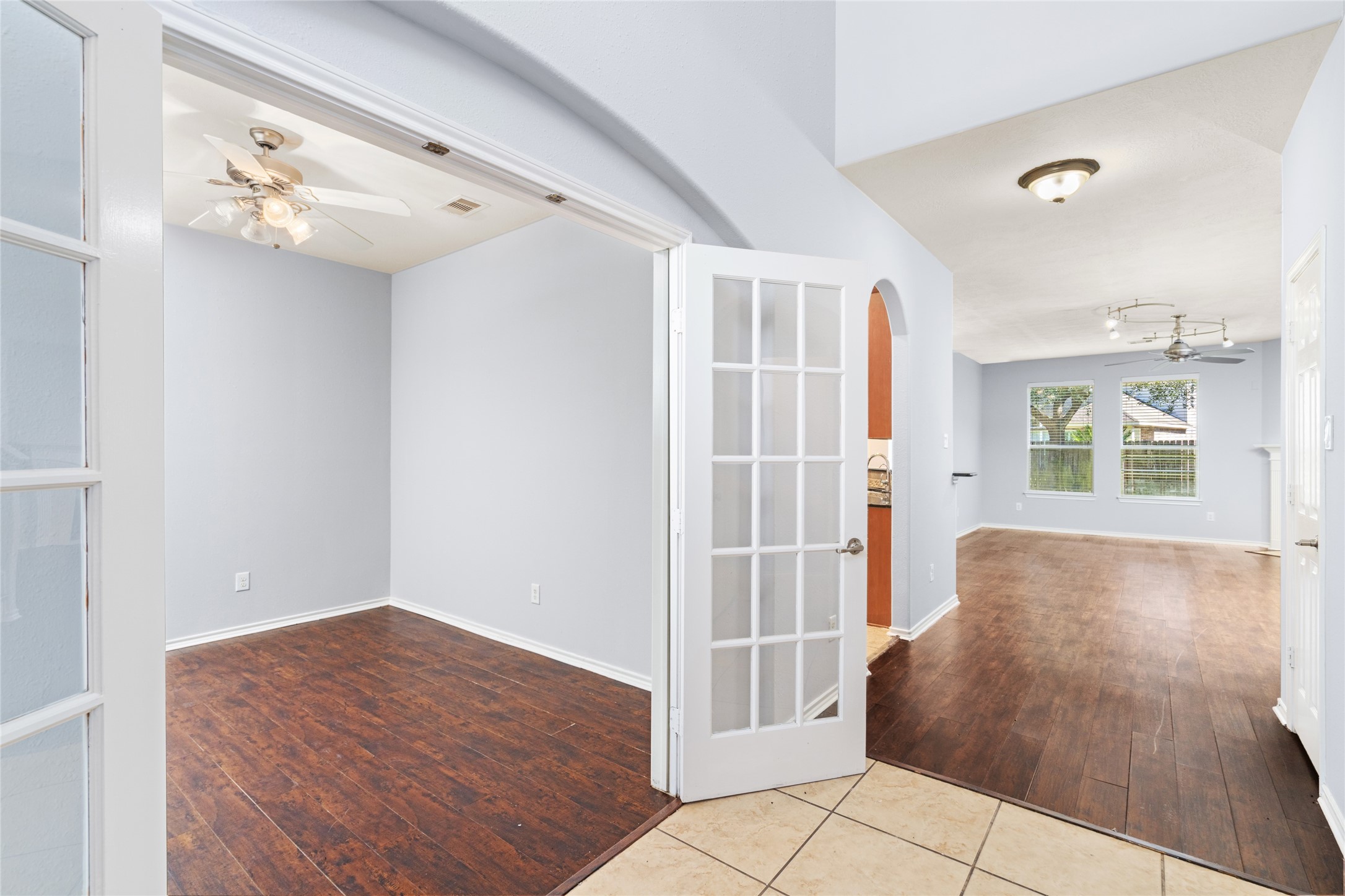 Elegant French doors invite you into a sunlit home office or study, blending style and functionality for your work-from-home needs.