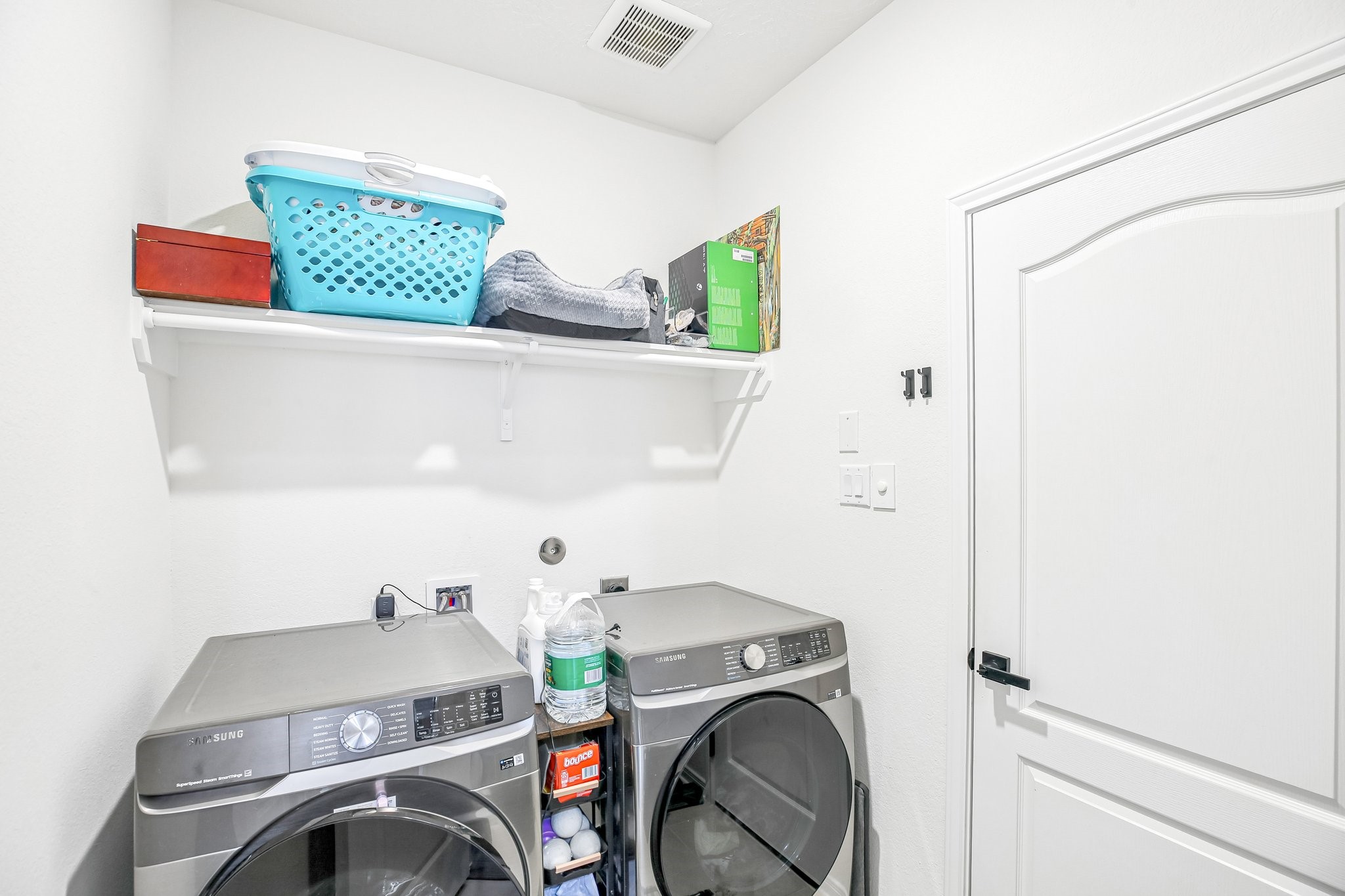 Spacious laundry room with additional shelving in the corner (not in photo)