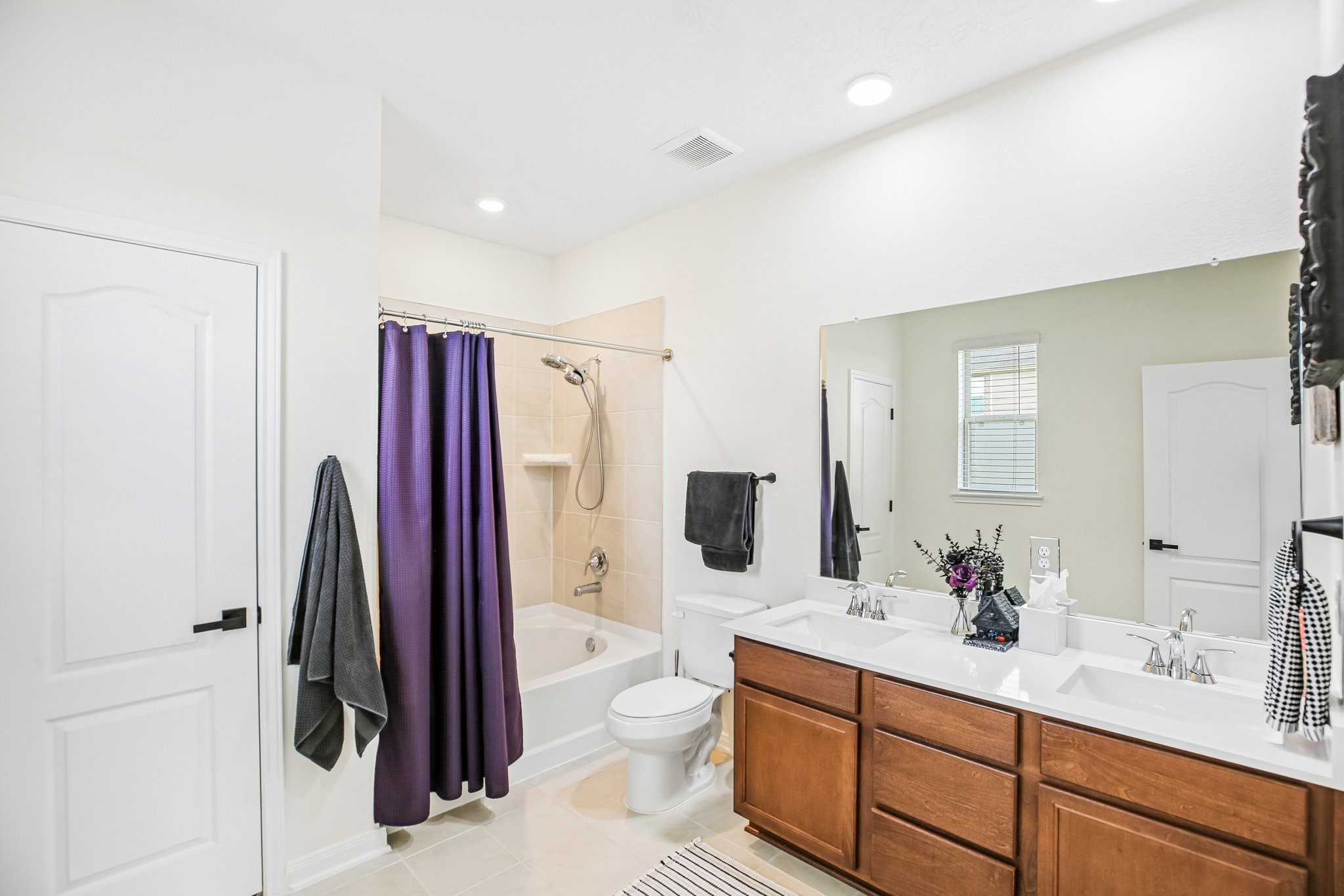 Primary bathroom has double sinks and large soaking tub/shower.
