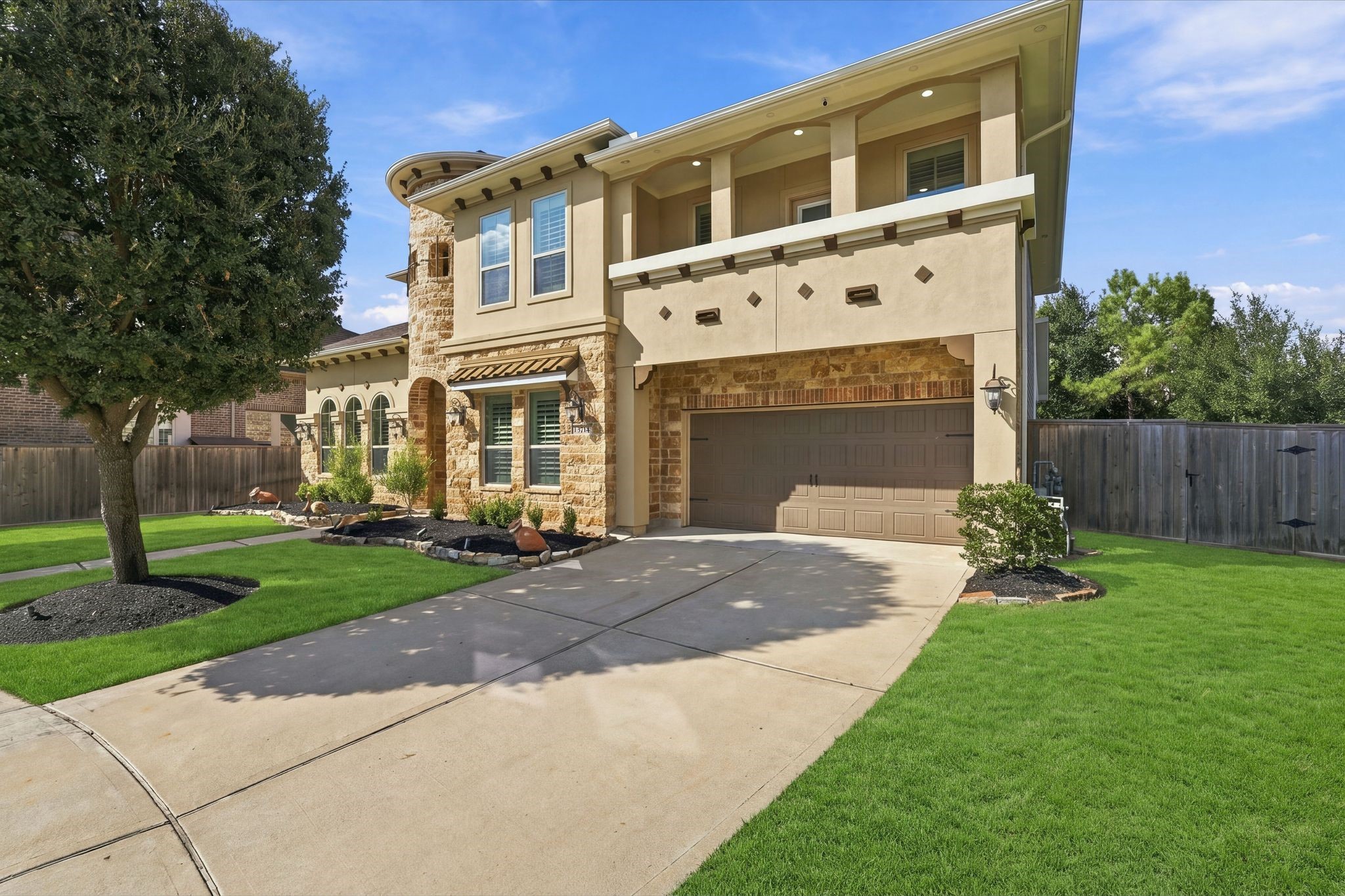 Beautiful curb appeal! This luxury two-story home in gated Wildwood at Northpointe features elegant stone and stucco architecture, a covered second-story balcony, manicured landscaping, and a 3-car tandem garage. Fresh exterior paint (2023) and a NEW Class 4 impact-resistant roof (2025)!