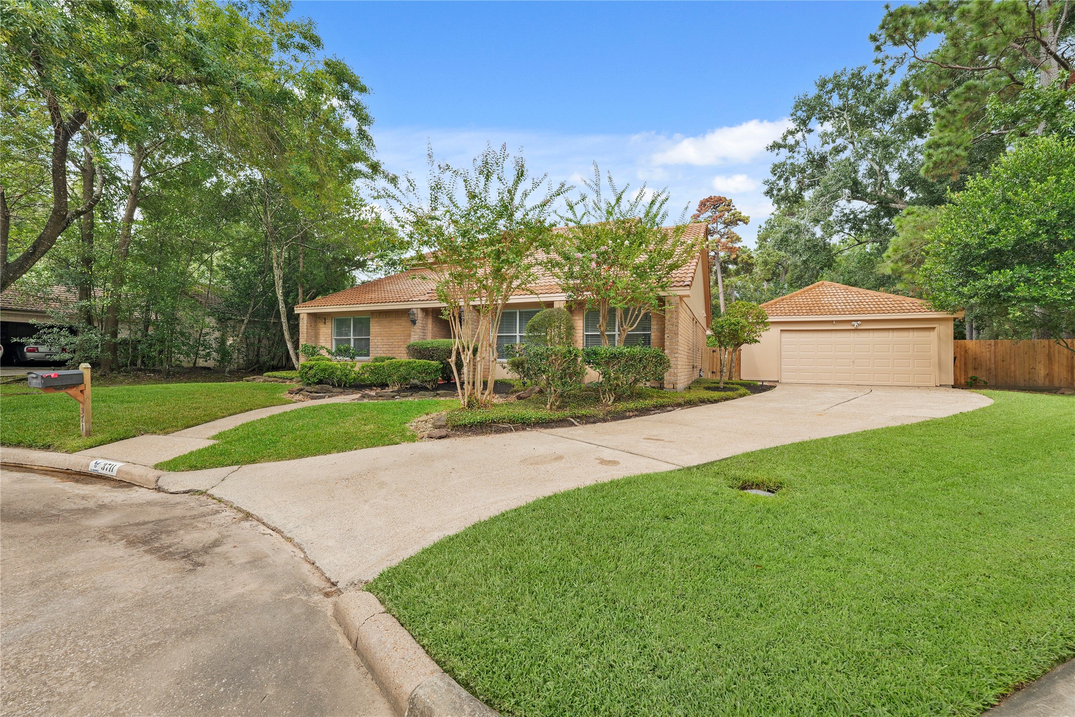Long driveway leads to spacious detached garage
