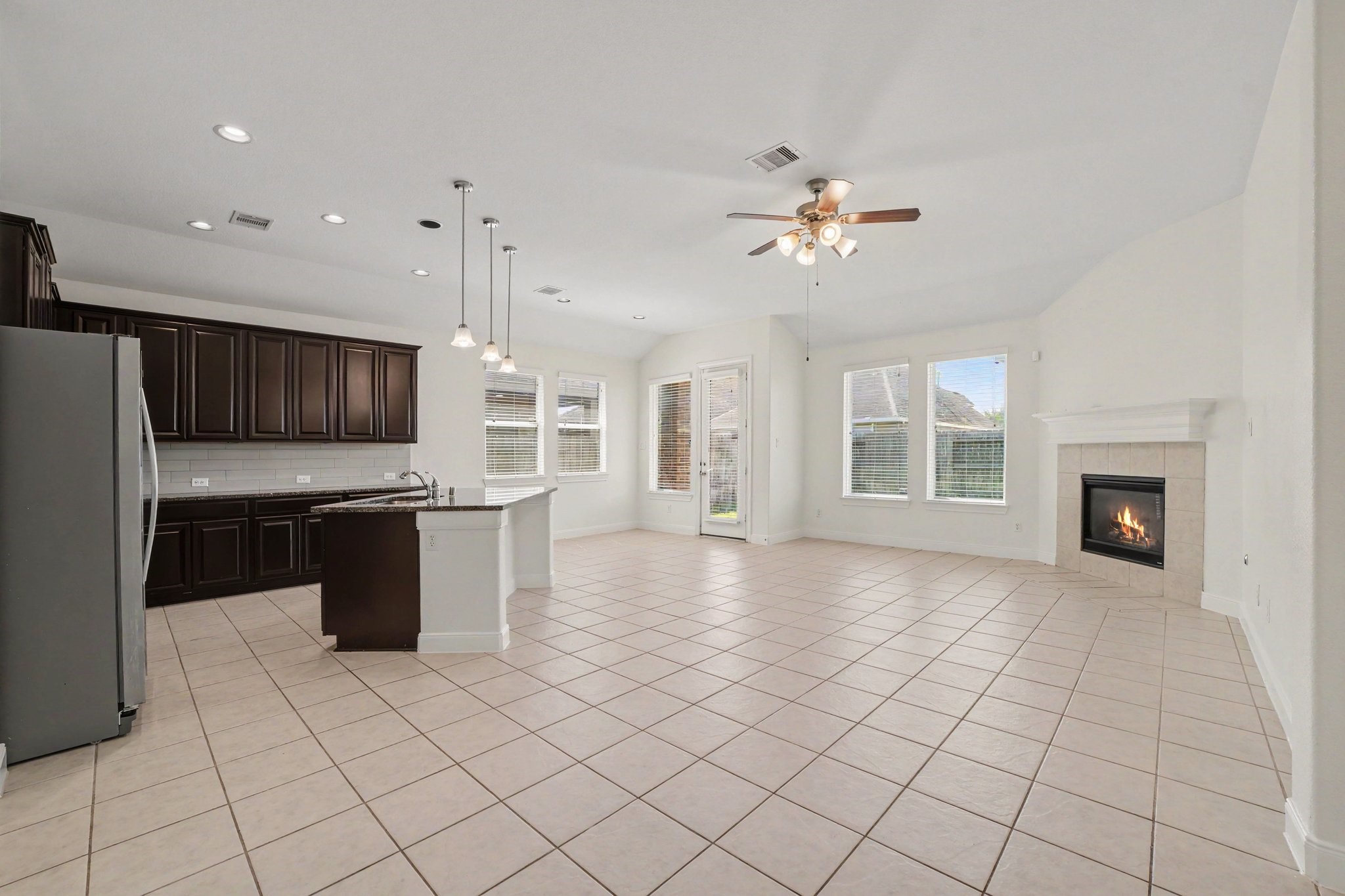 Step inside the heart of the home, an open-concept kitchen overlooking the breakfast area and spacious living room