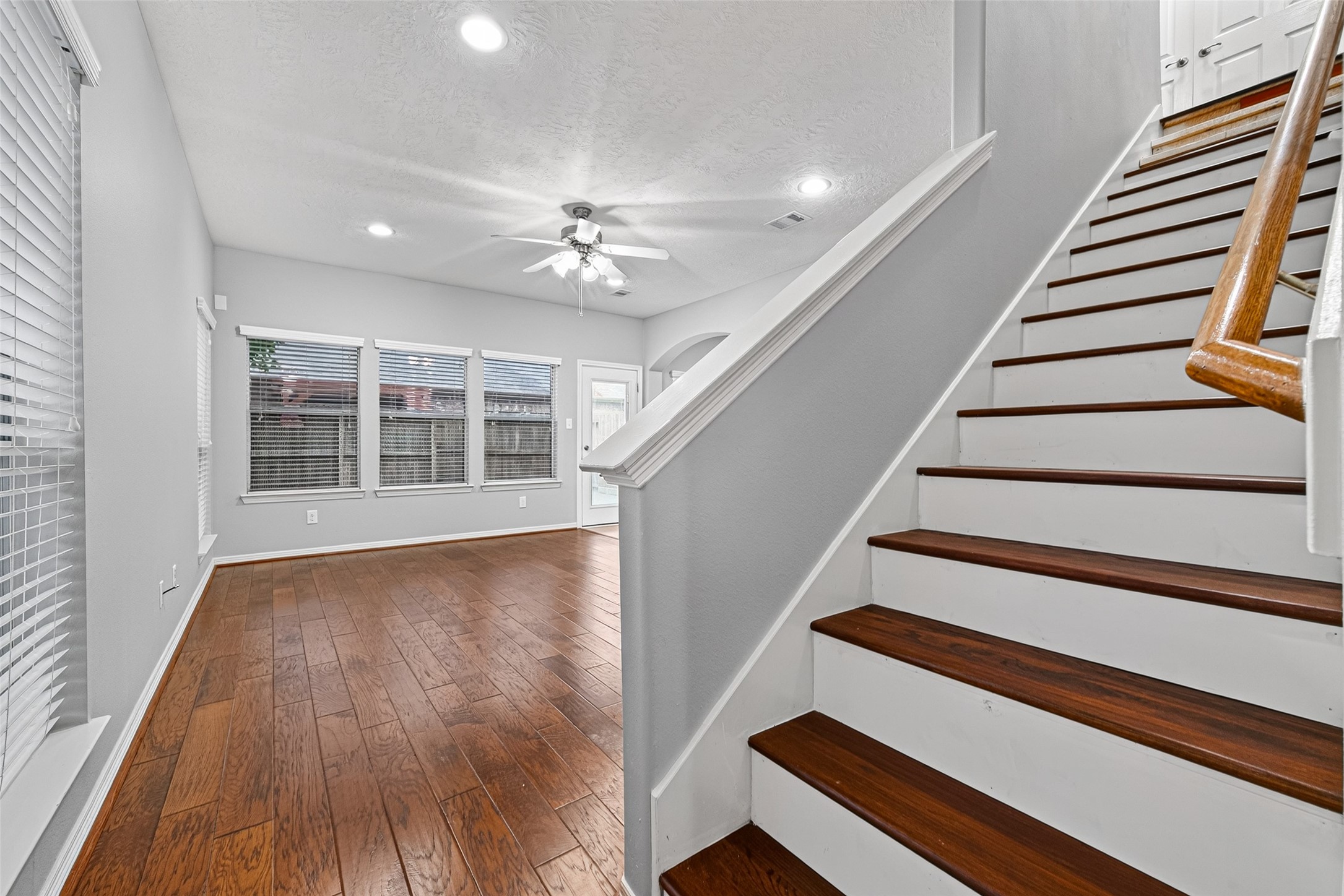 Wood floors in the living room and oak steps lleading to the three bedrooms.