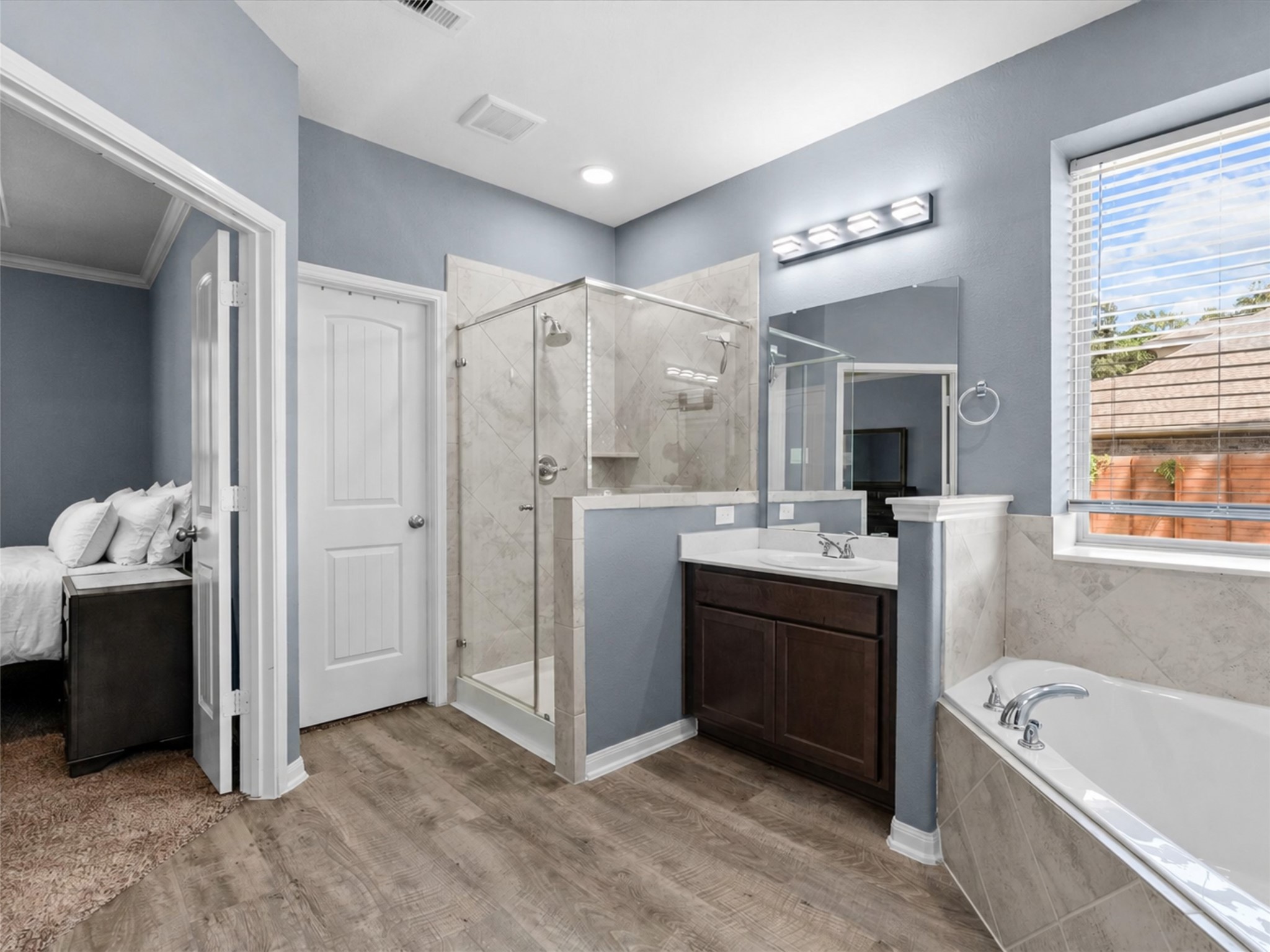 The primary bath offers a separate shower, soaking tub and plenty of space to get ready with ease.