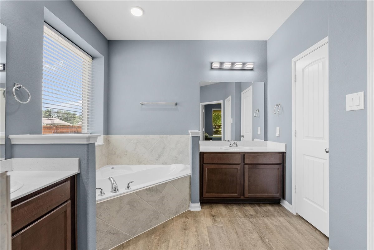 Unwind in the soaking tub and enjoy a bright primary bath filled with natural light.