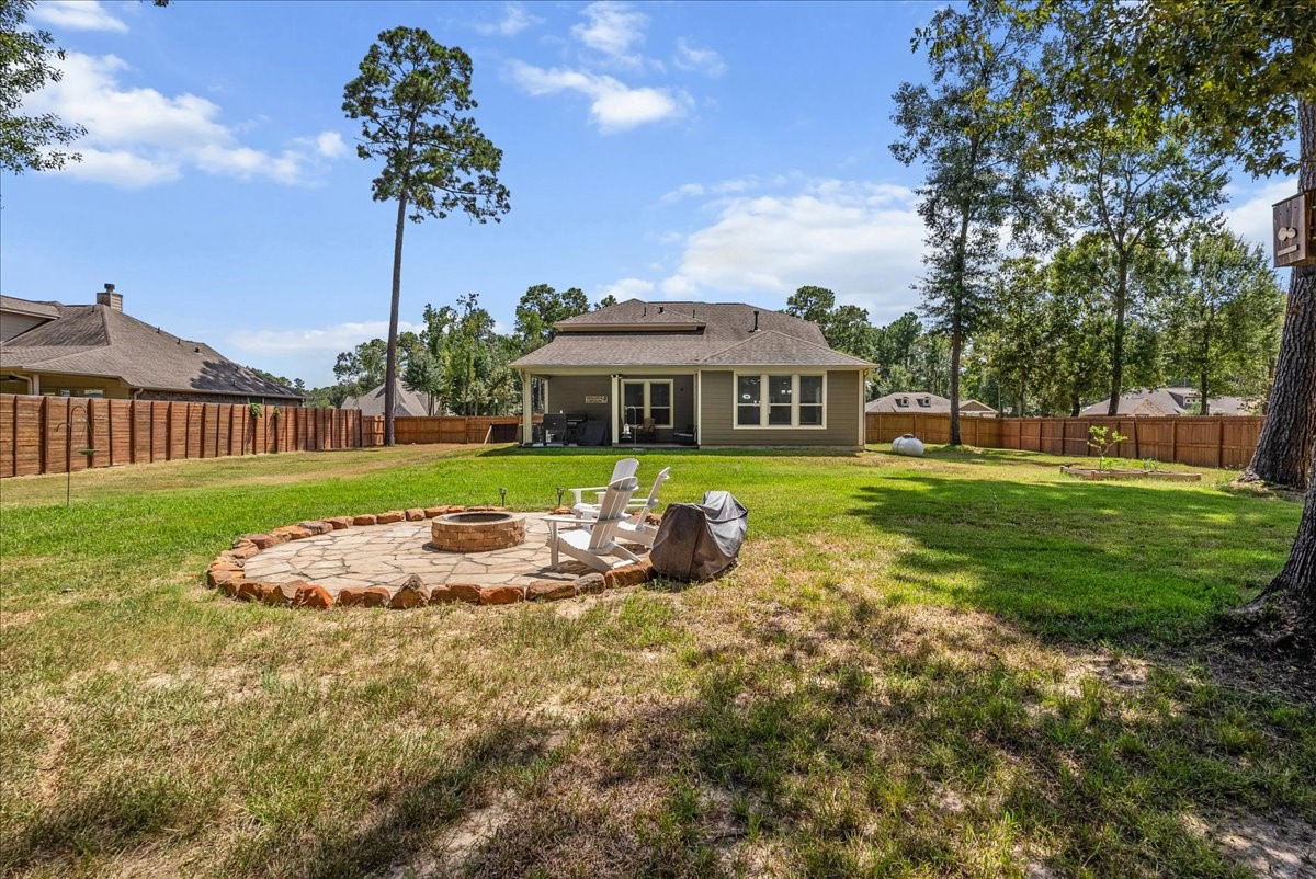 The expansive backyard and custom fire pit create a wonderful setting for outdoor living and entertaining.