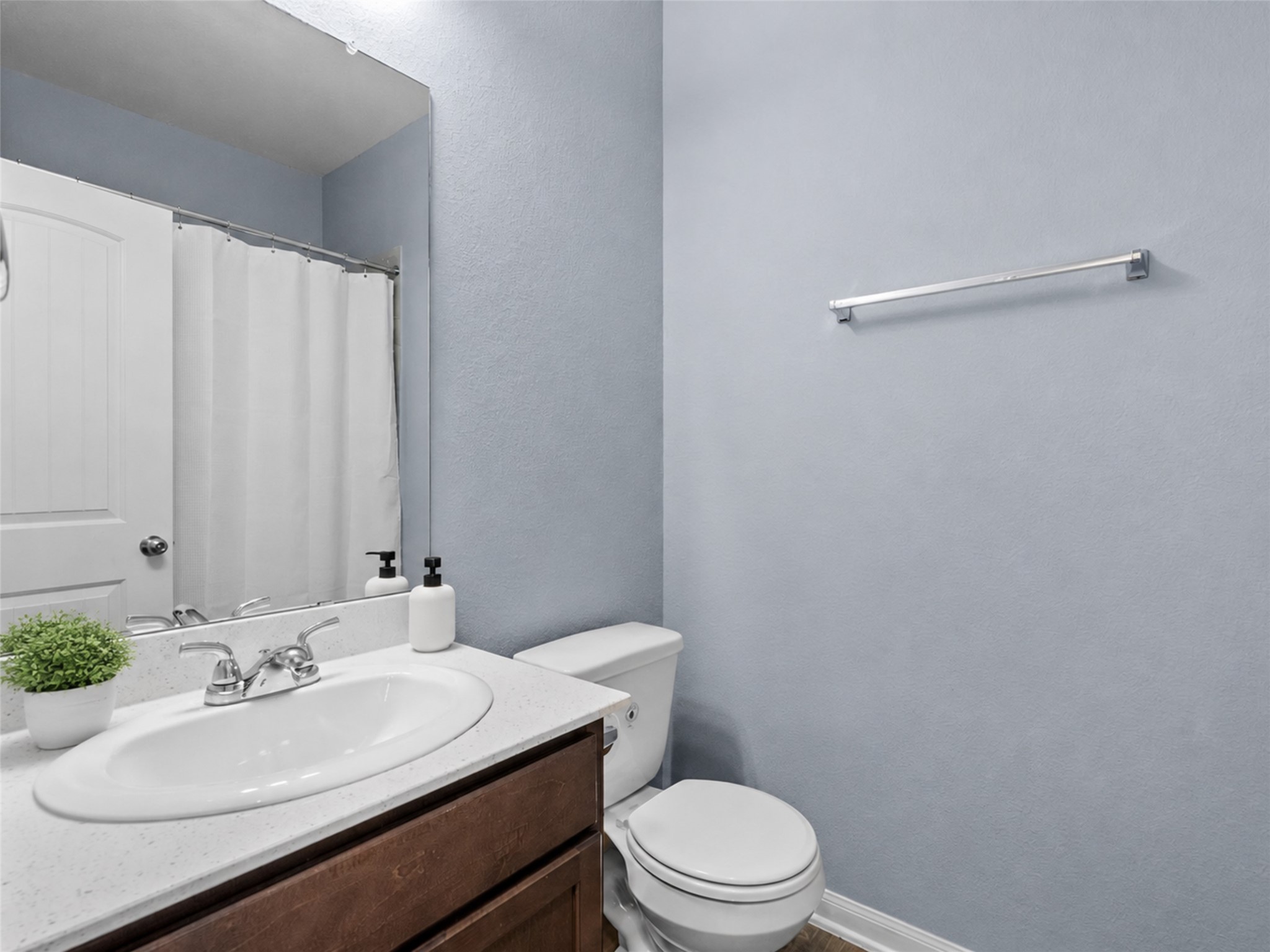 Convenient downstairs half bath is perfectly positioned for family and guests.