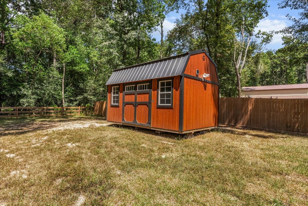 Large storage shed provides convenient space for lawn equipment, tools, outdoor toys and more.