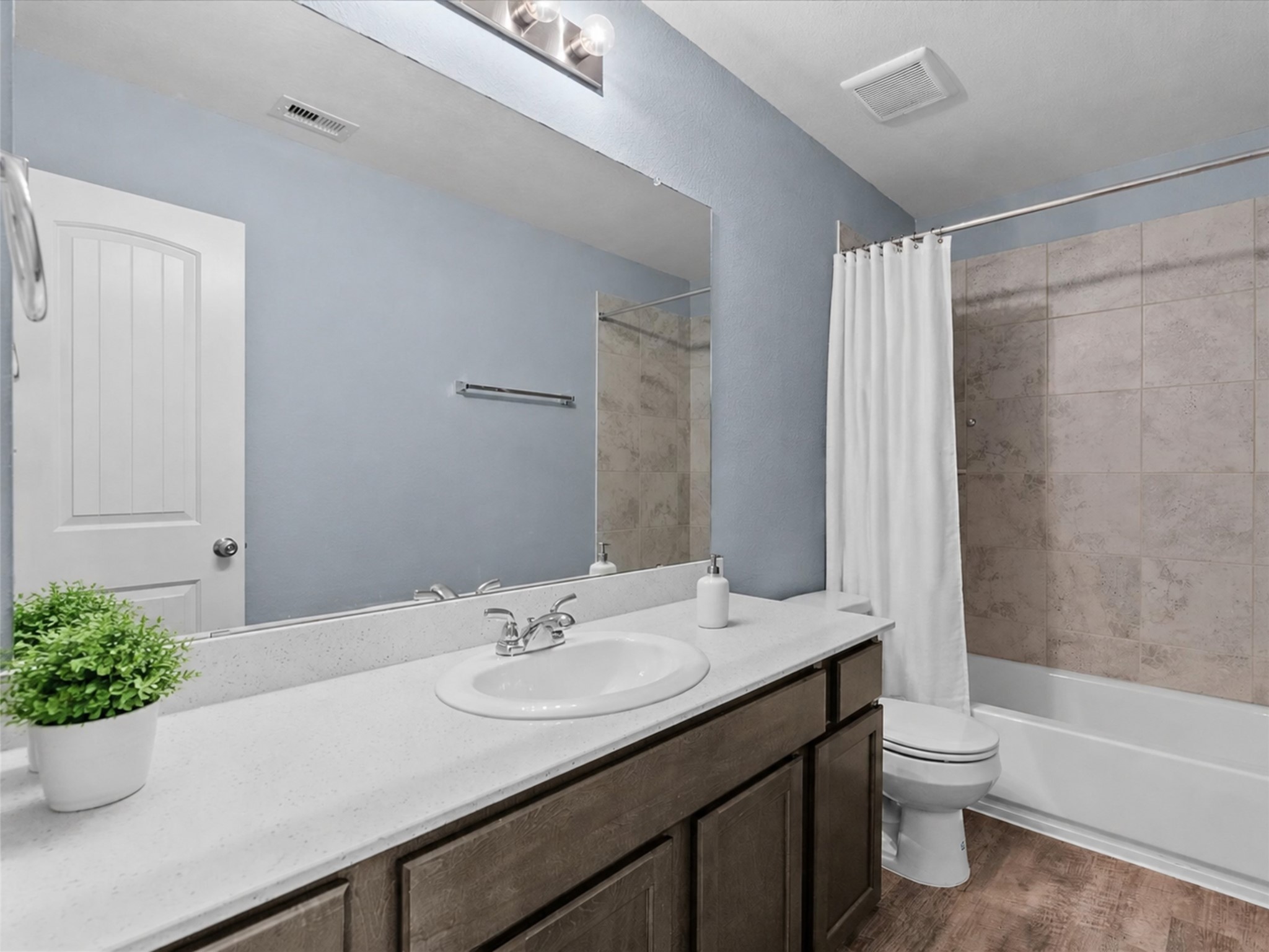 Full secondary bathroom offers generous counter space and a convenient tub/shower combination.