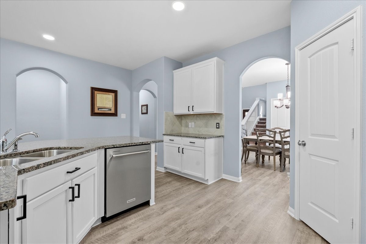 The functional kitchen offers generous granite counter space, abundant cabinetry and easy access to the living areas.