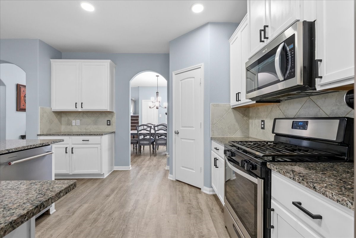 Gas cooking, stainless appliances and a stylish backsplash make this kitchen as functional as it is inviting.