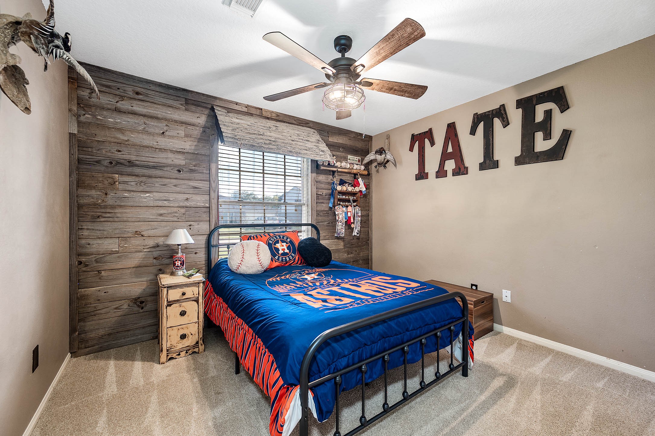 Secondary bedroom with custom wood wall