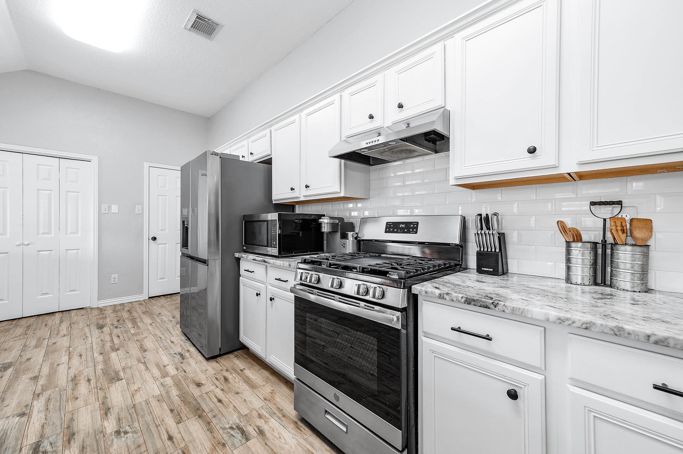 Marble countertops, beautiful backsplash, stainless steel appliances