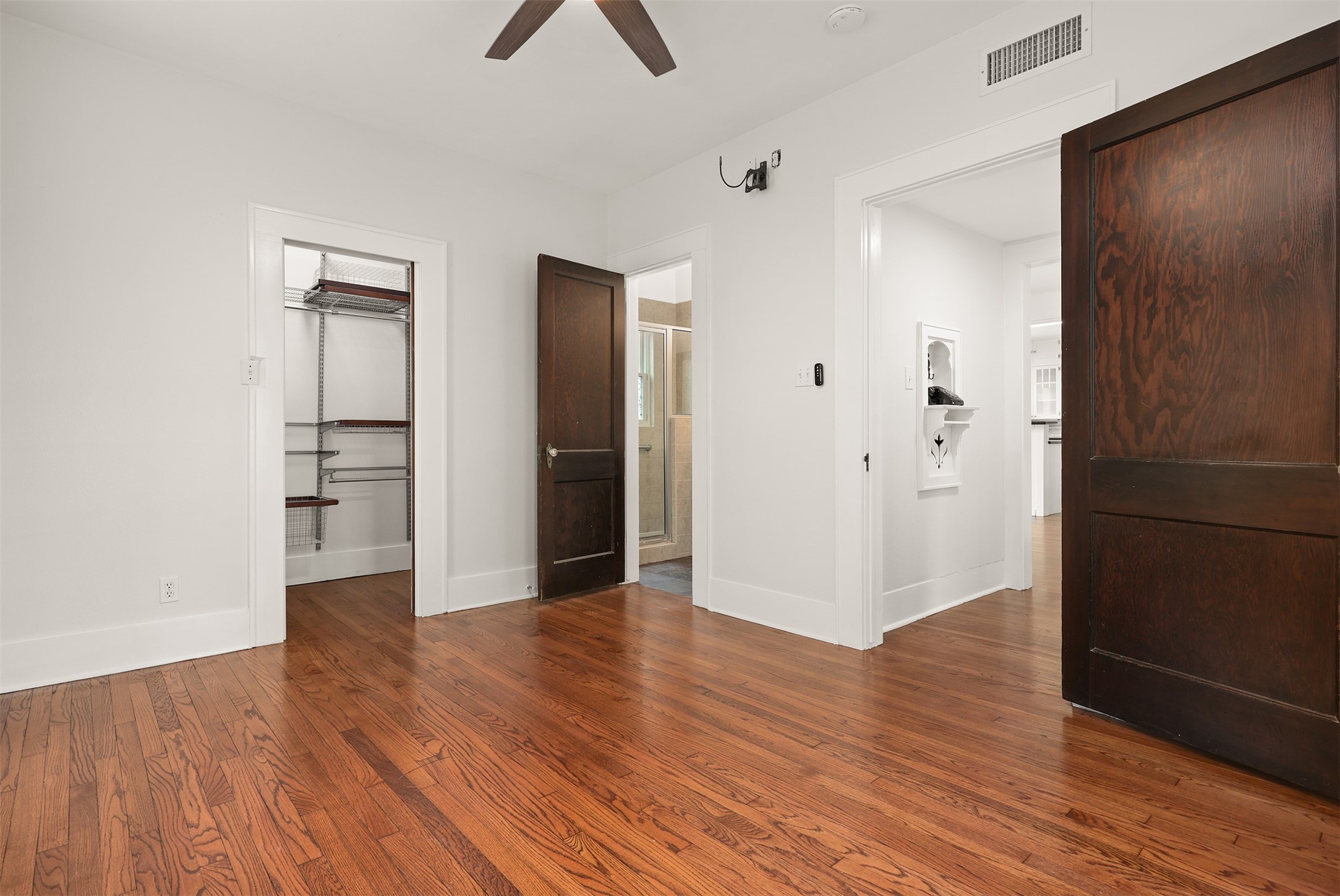 Versatile walk in closet with shelving you can customize.