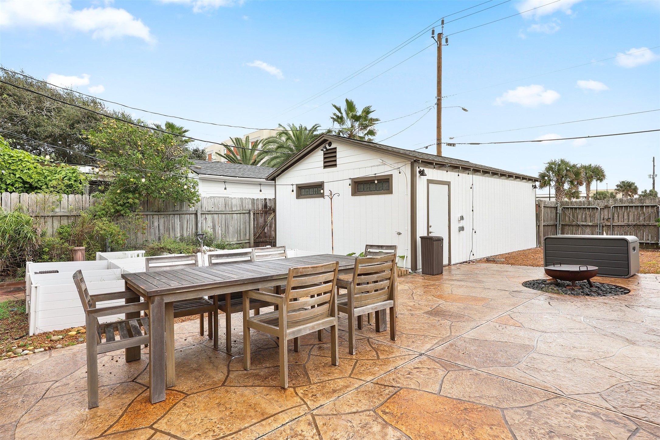Spacious backyard patio with room for a dining area and fire pit.
