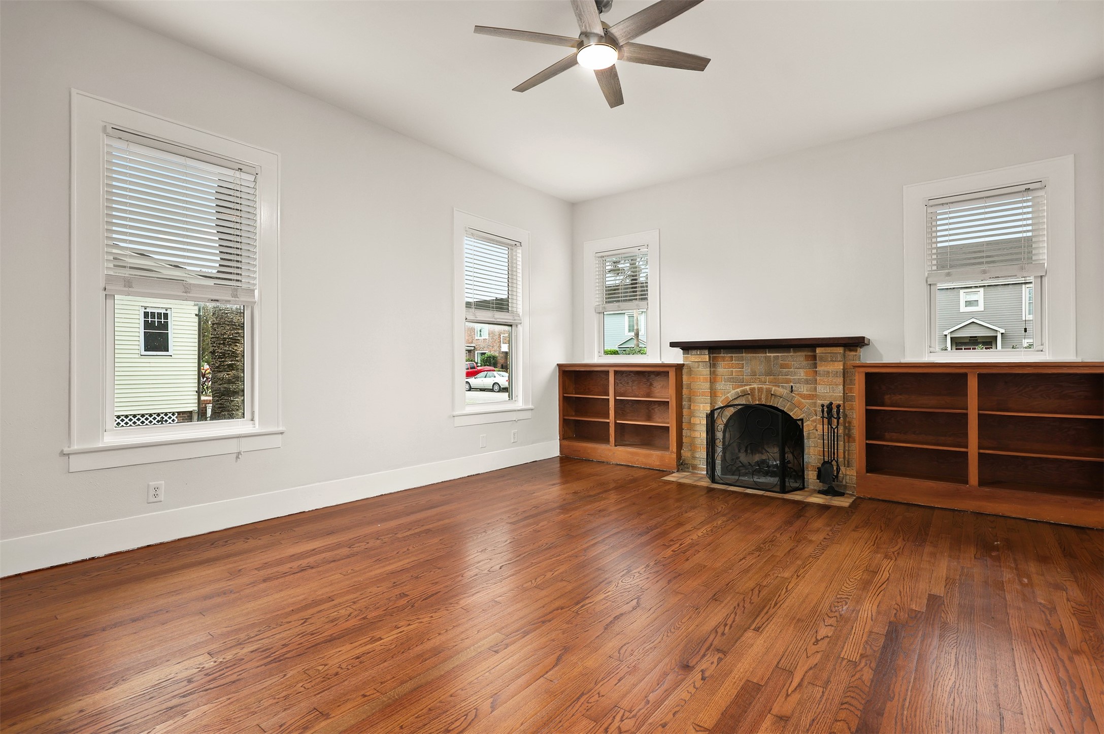 Abundant natural light from the large windows with rich hardwood floors.