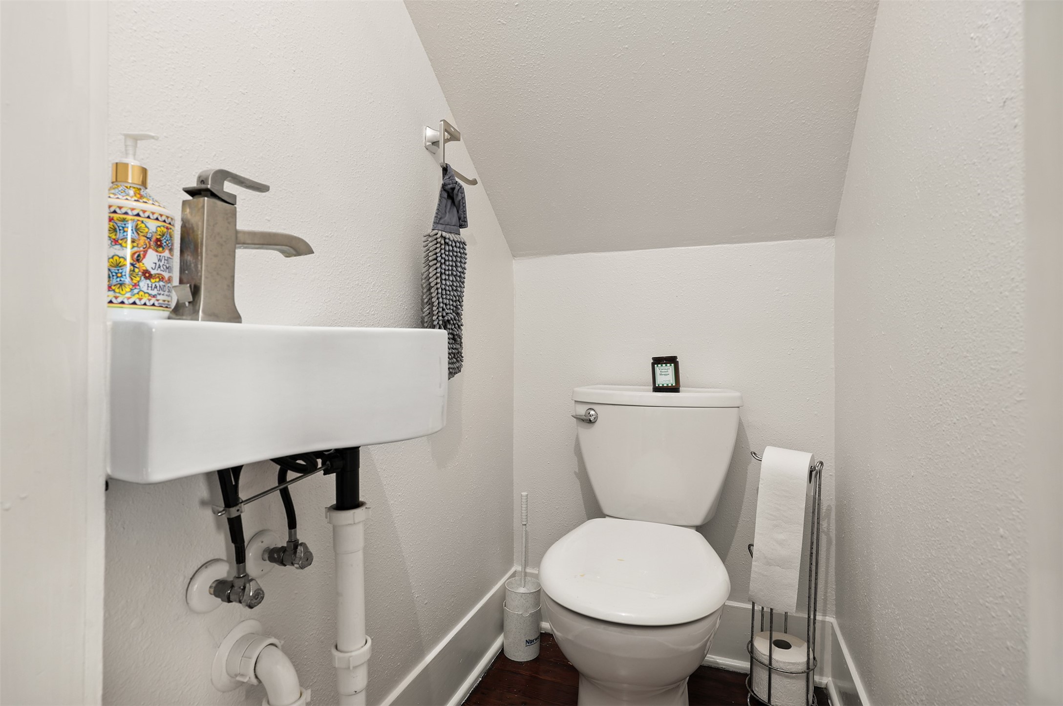 Cozy half-bath with a modern sink and efficient use of space, perfect for guests.