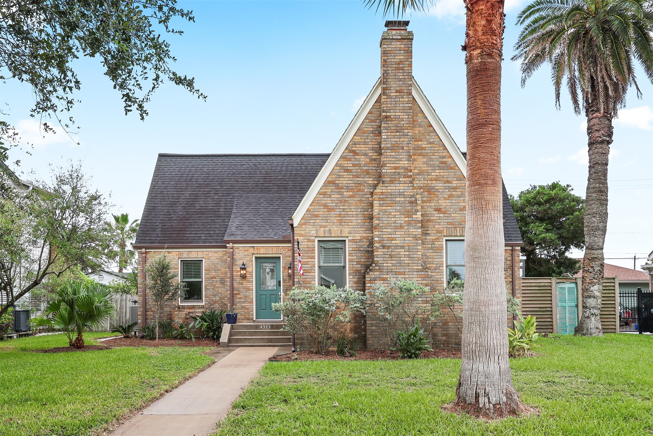 Craftsman brick home with steep gabled roof offers inviting curb appeal in this quiet neighborhood.